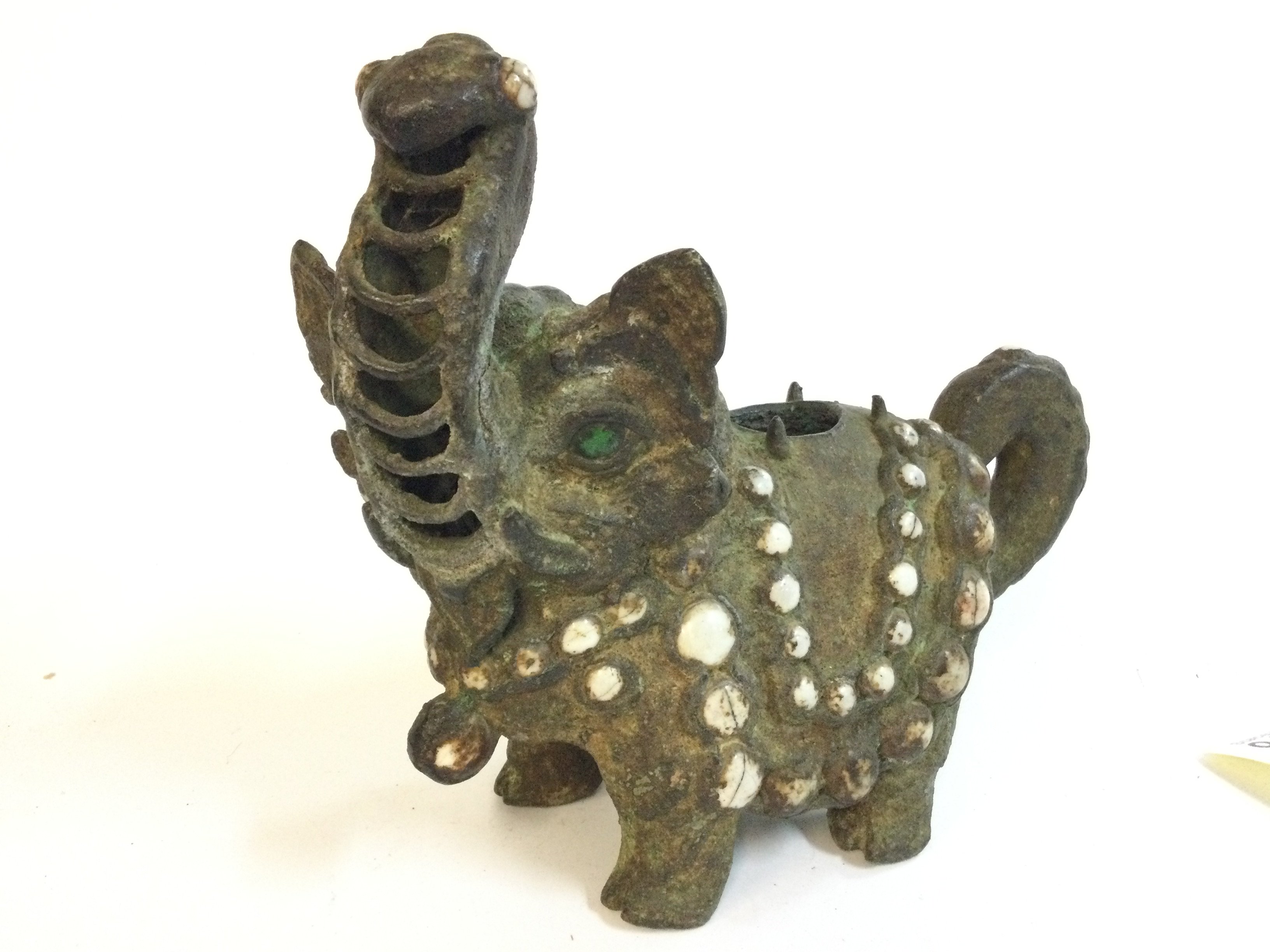 An Asian oriental cast metal elephant censer , 19cm tall approximately. 22cm wide . Postage category B