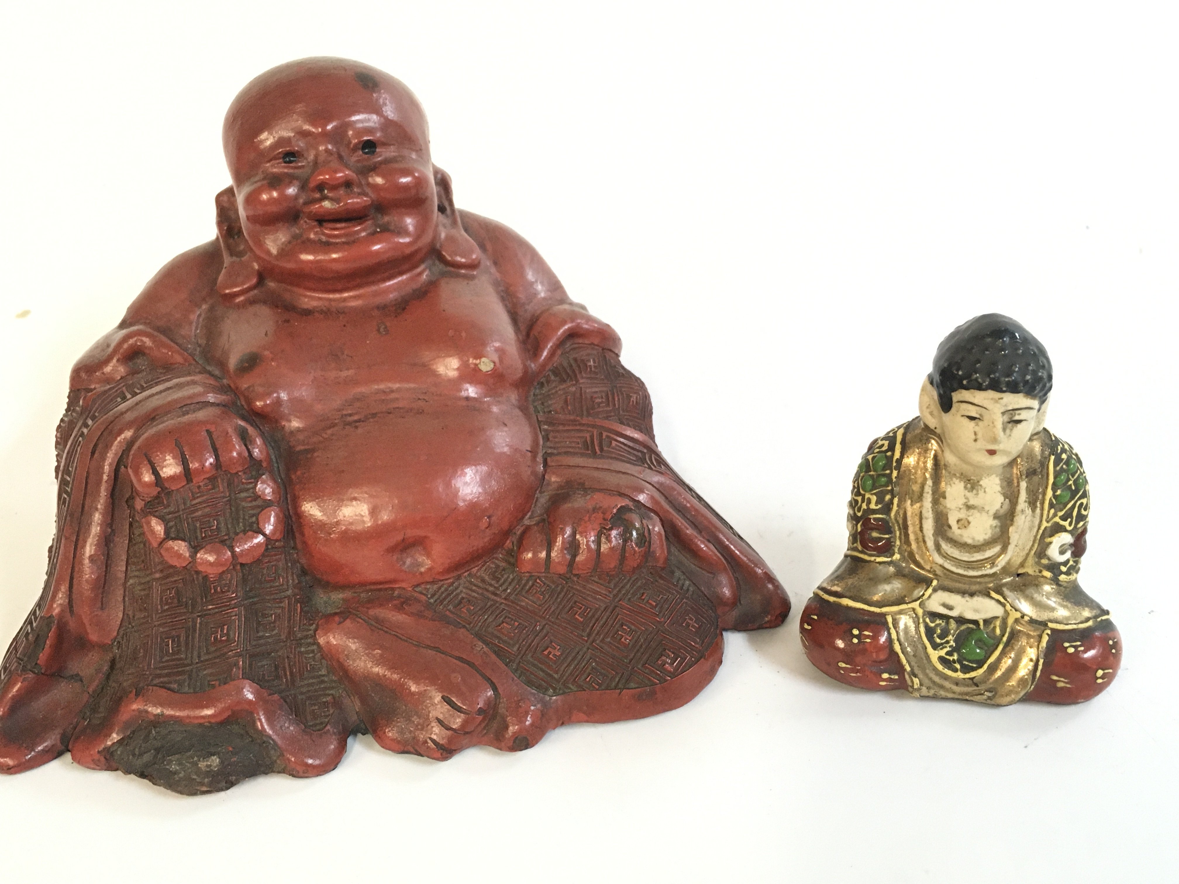A Chinese 19th century porcelain Buddha and red cinnabar carved Buddha .