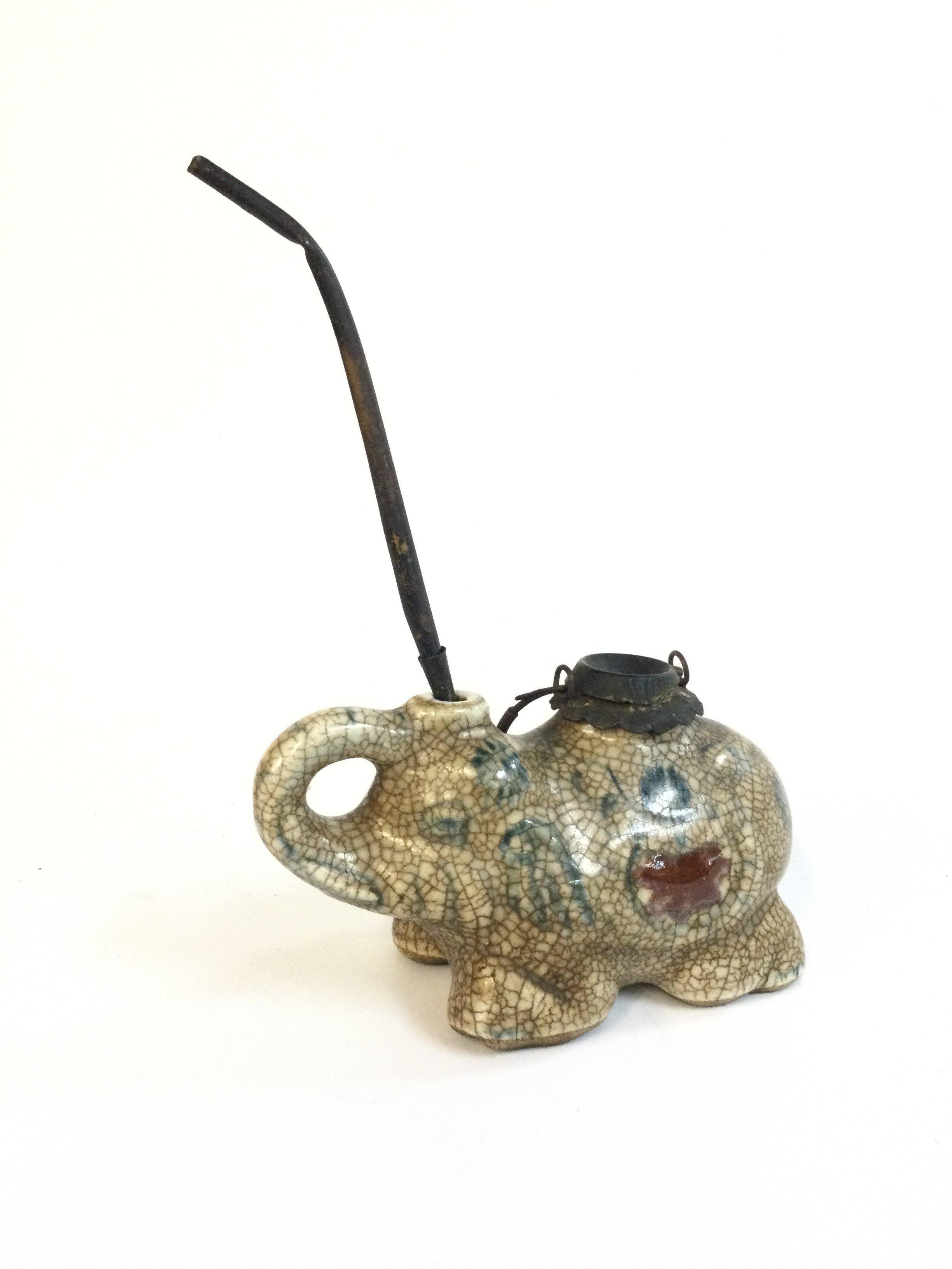 A Chinese crackle glazed porcelain elephant opium smoking pipe . Dimensions 9cm tall 15cm long approximately