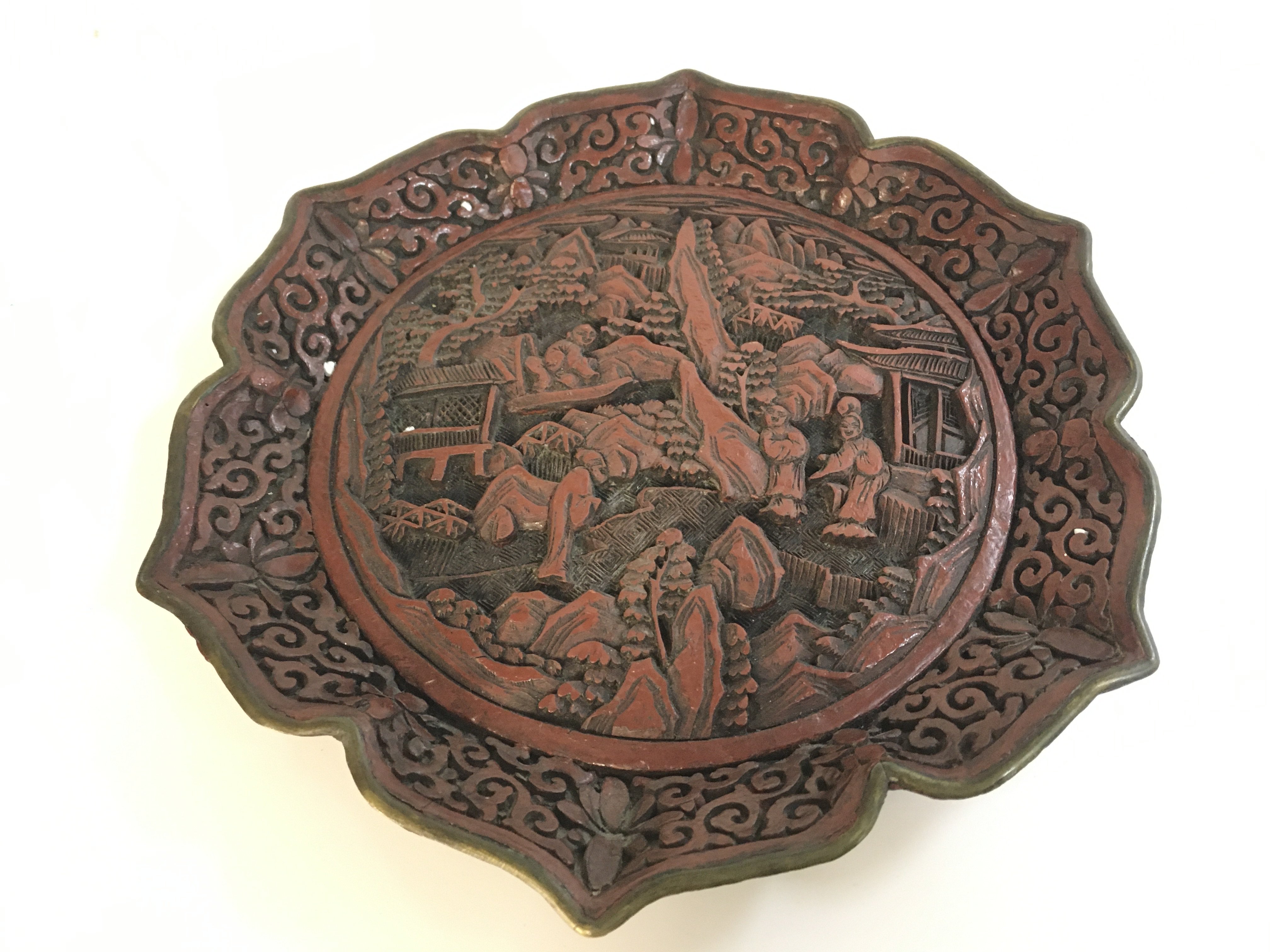 A Chinese red cinnabar plate signed with a six character mark at the base . 22cm wide Approx . Postage cat b