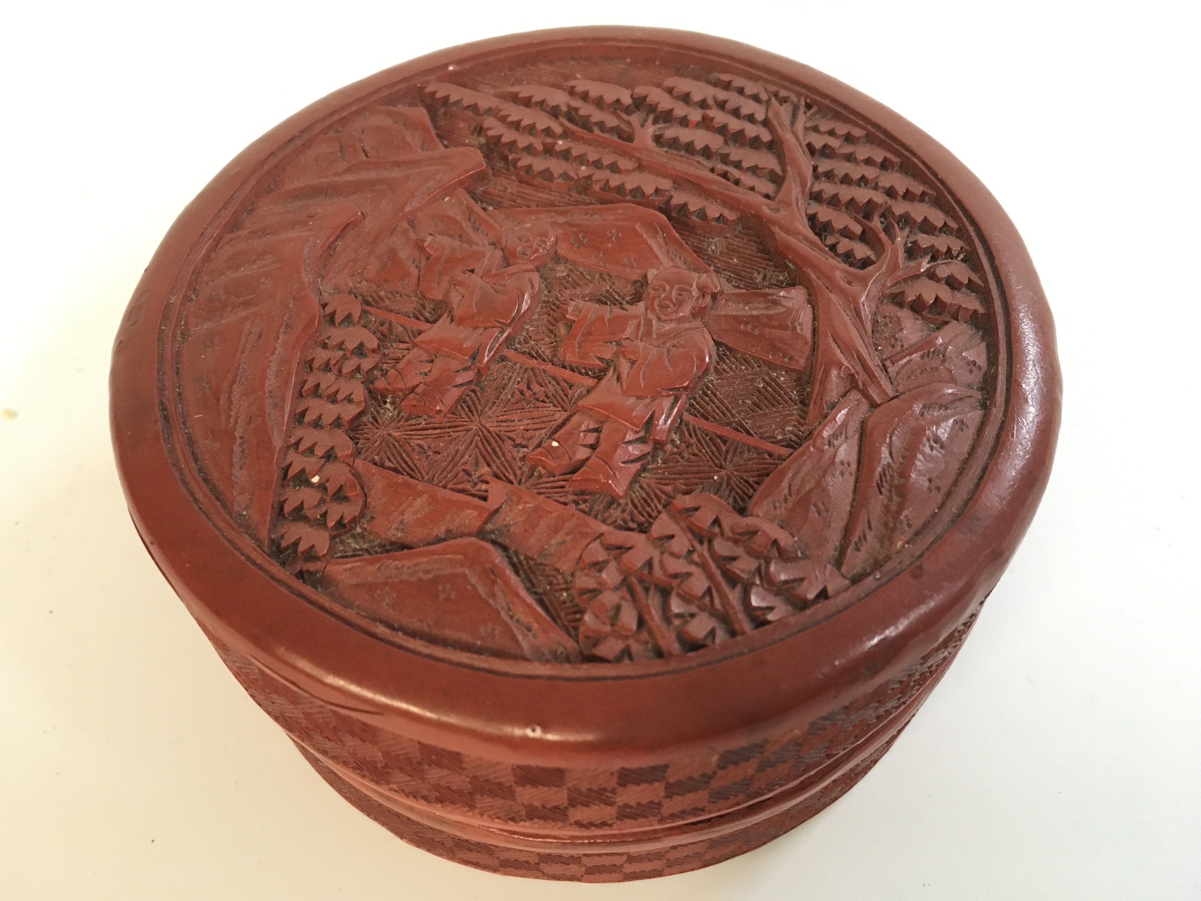 A Chinese red cinnabar box, 10cm wide 5cm tall. Postage category A