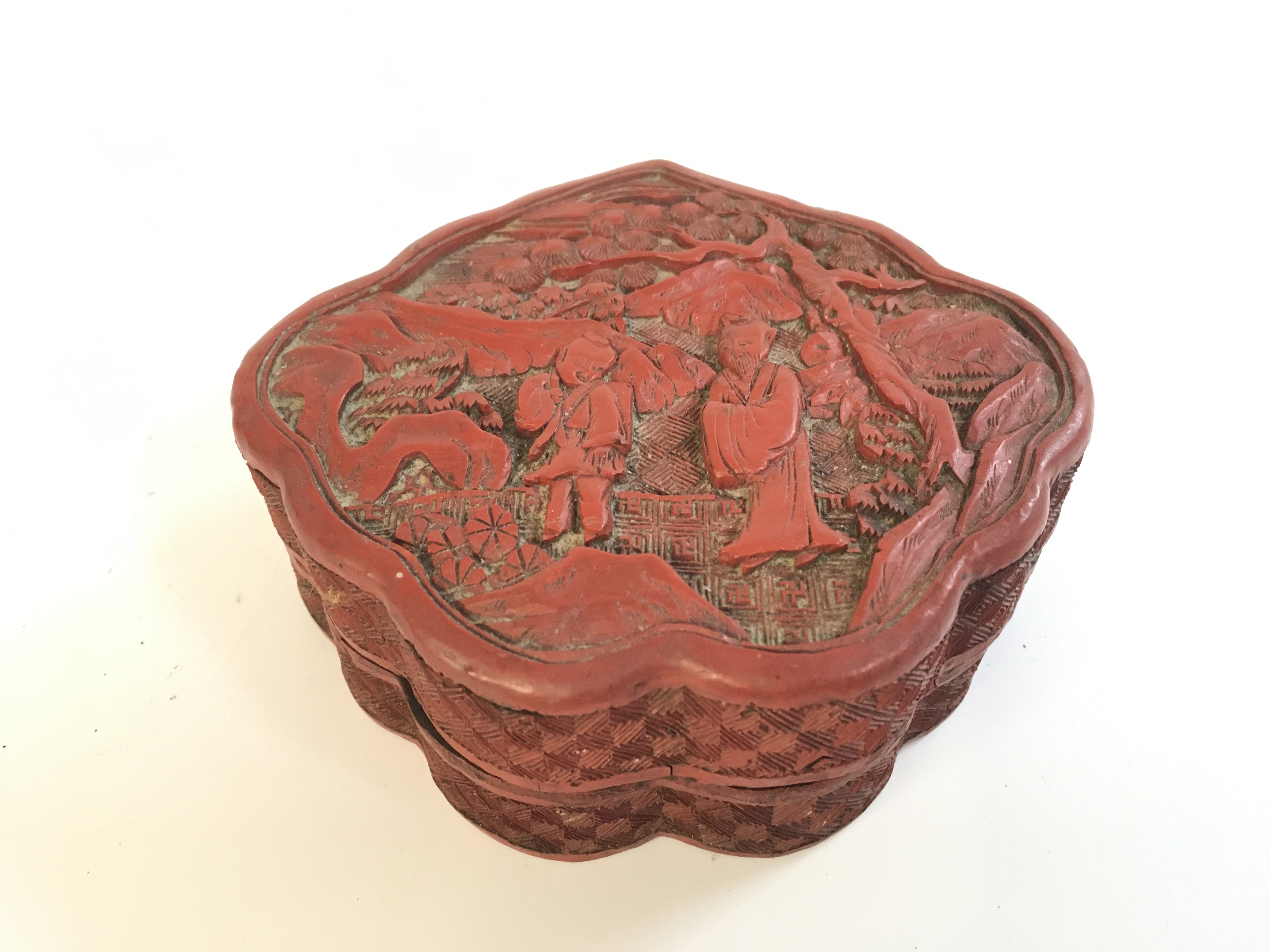 A Chinese red cinnabar box ,11cm wide . Postage category A