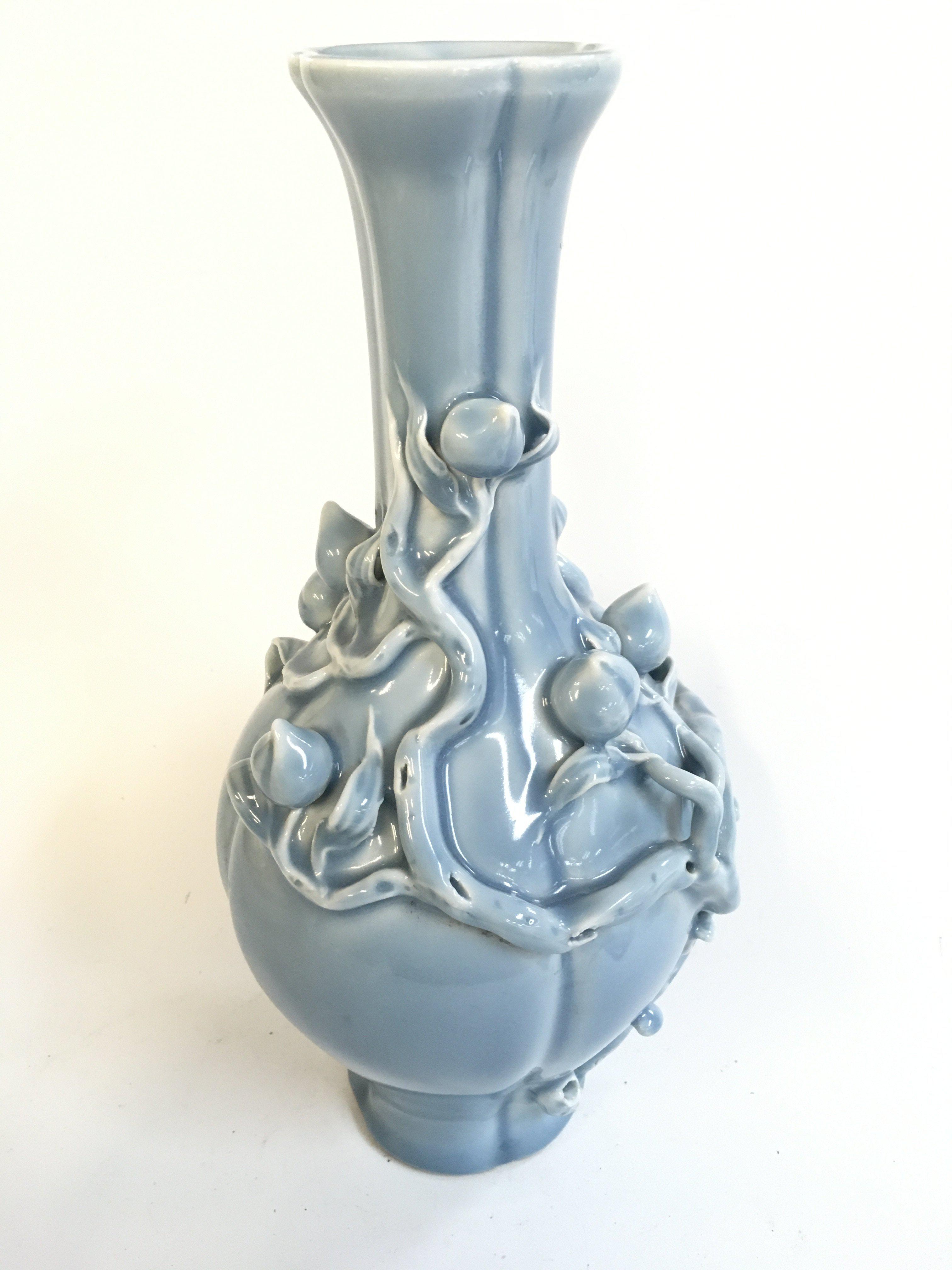 A Chinese porcelain blue powder with peach blossom relief vase , with a six character mark at base. 32cm tall approximately