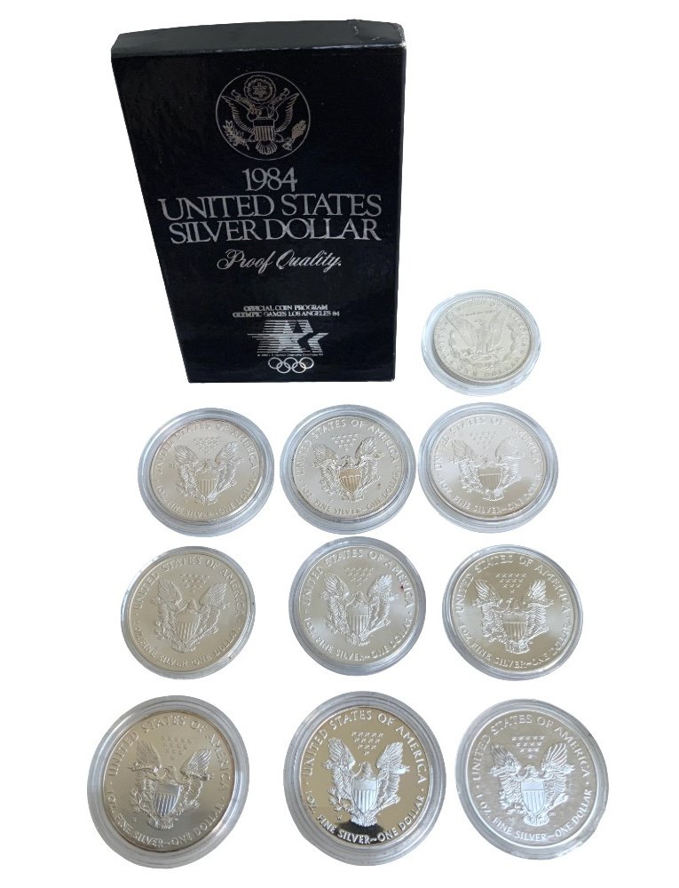 A collection of American 1 Dollar pieces. 1881 Morgan Dollar, 1984 Proof boxed, Bullion 1Ounce fine silver, 2000, 2005 with Paper label overlay decoration, 5 x 2011 (Matt Proof/ 1 Mirror finish), 2019, 2021. (A)