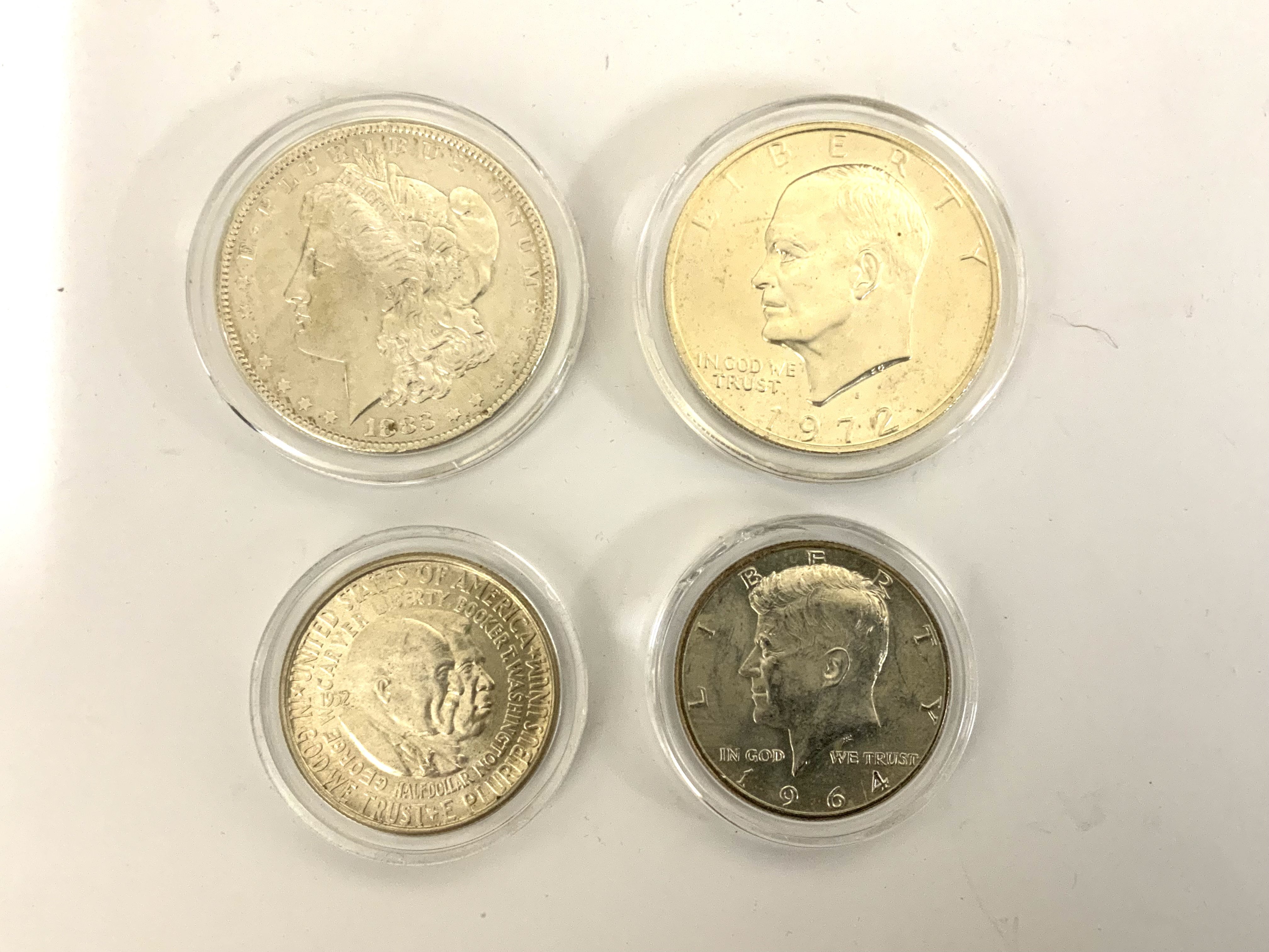 1883 American Dollar, 1972 Liberty Dollar, 1964 Liberty Half dollar, 1952 Washington-Carver Half Dollar.