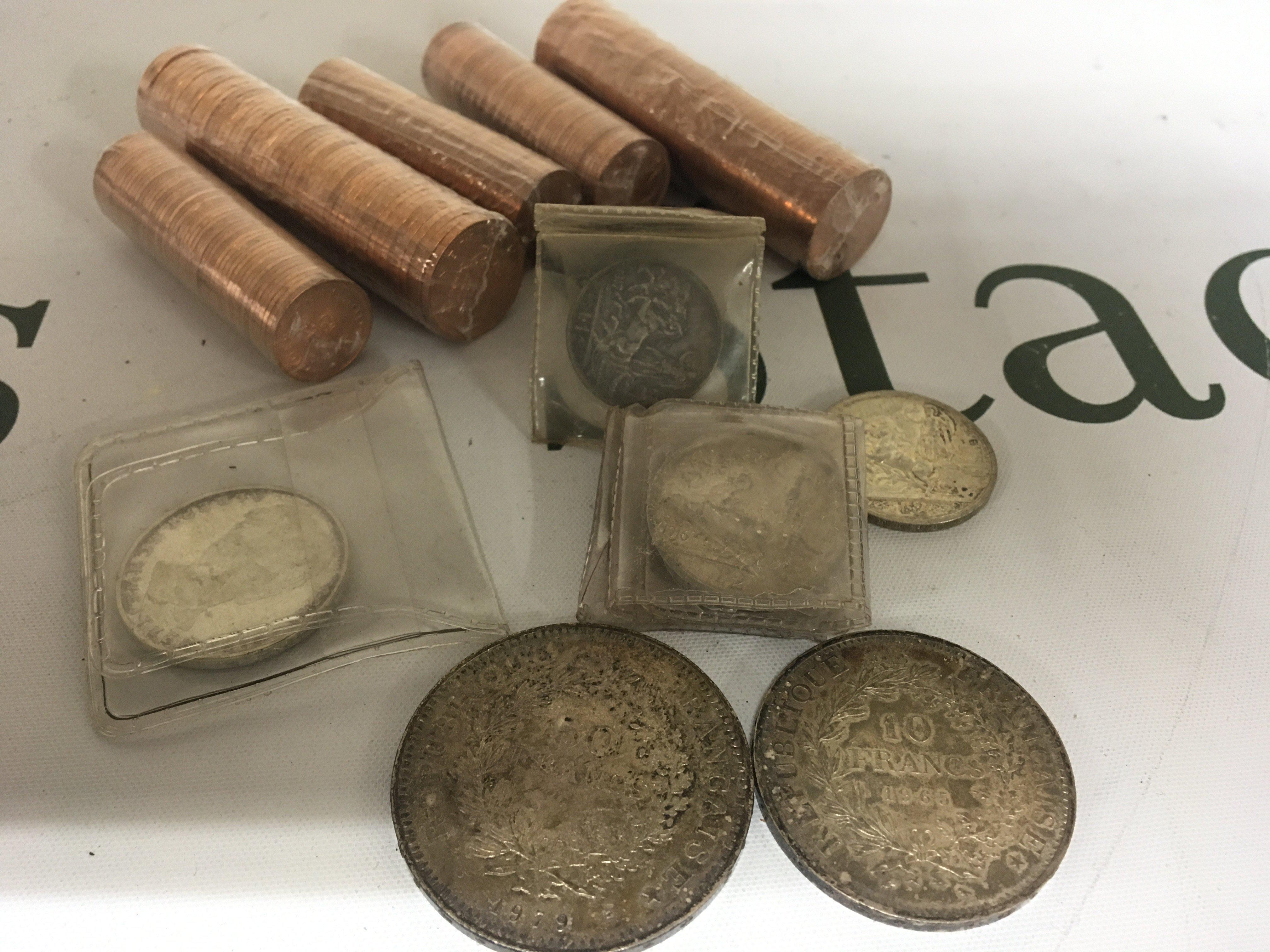A collection of Early 20th Century Italian lire German Five mark commemorative coin French 1979 50 Franc and 1965 10 Franc coin and a quantity of uncirculated British decimal pennys and half pennys.