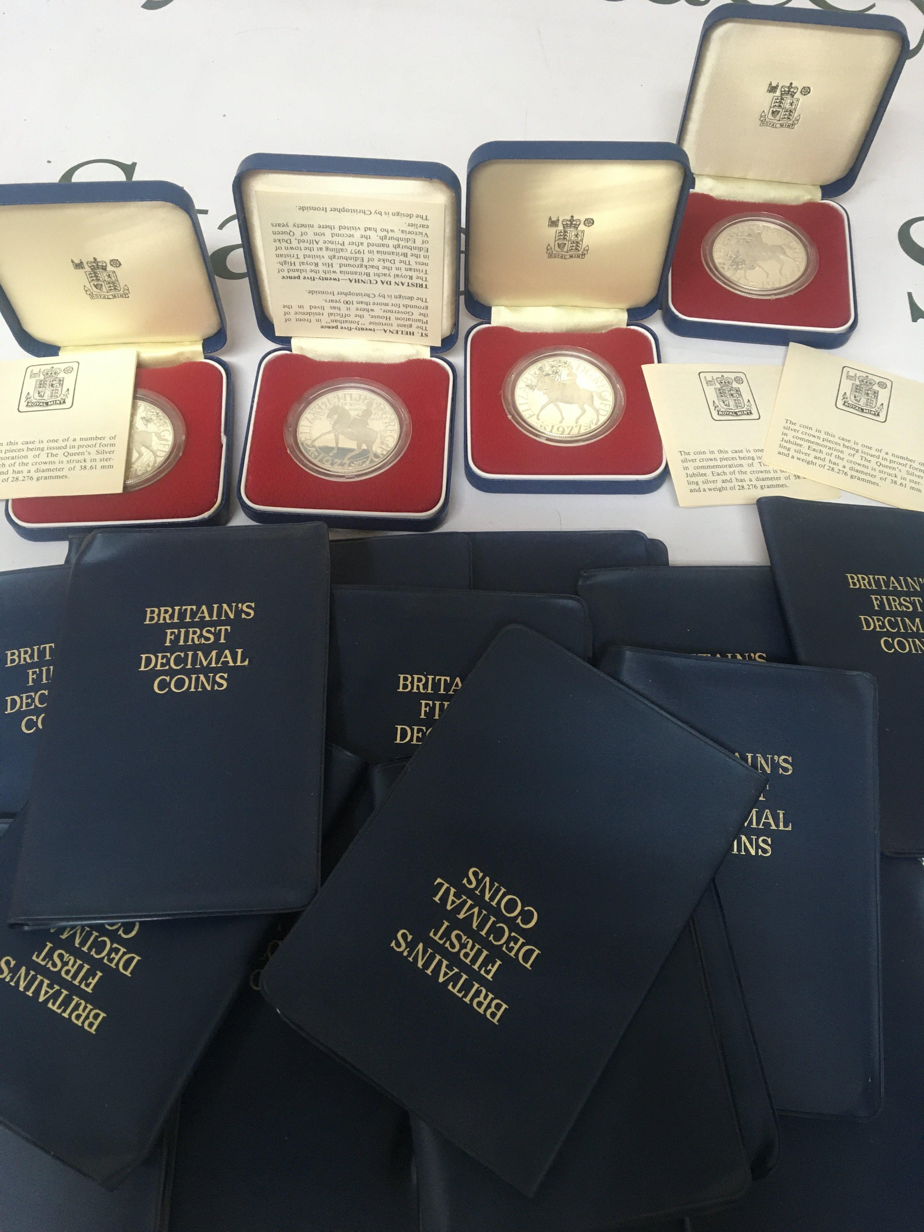 Four Elizabeth II Silver Jubilee sterling silver crowns in cases with Certificates and a large quantity of Britain&rsquo;s First Decimal coin sets.