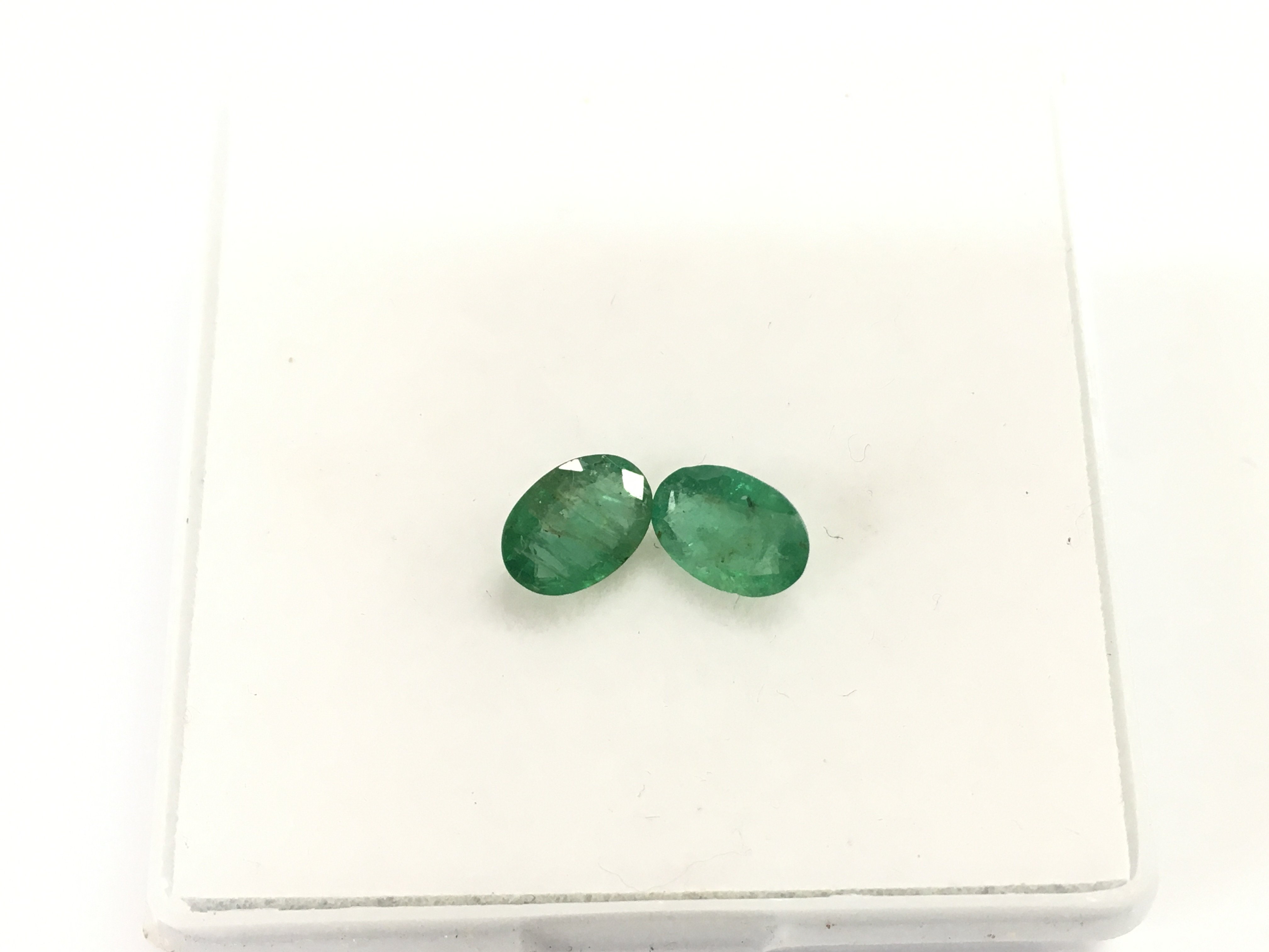 Pair of loose emeralds totalling 1.28ct. Postage B