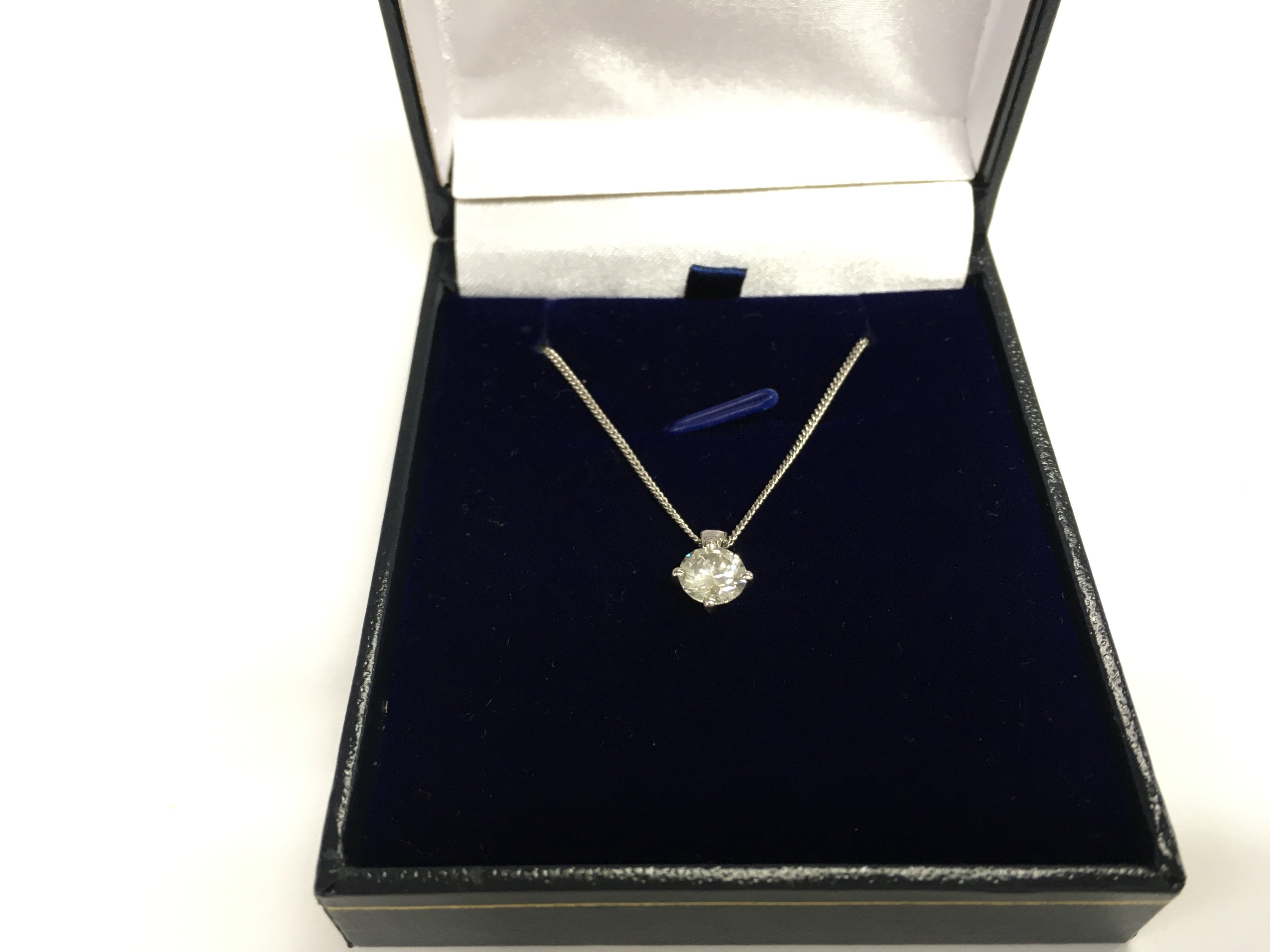 A platinum diamond solitaire pendant on a silver chain. Diamond Approx 0.91ct. Postage B