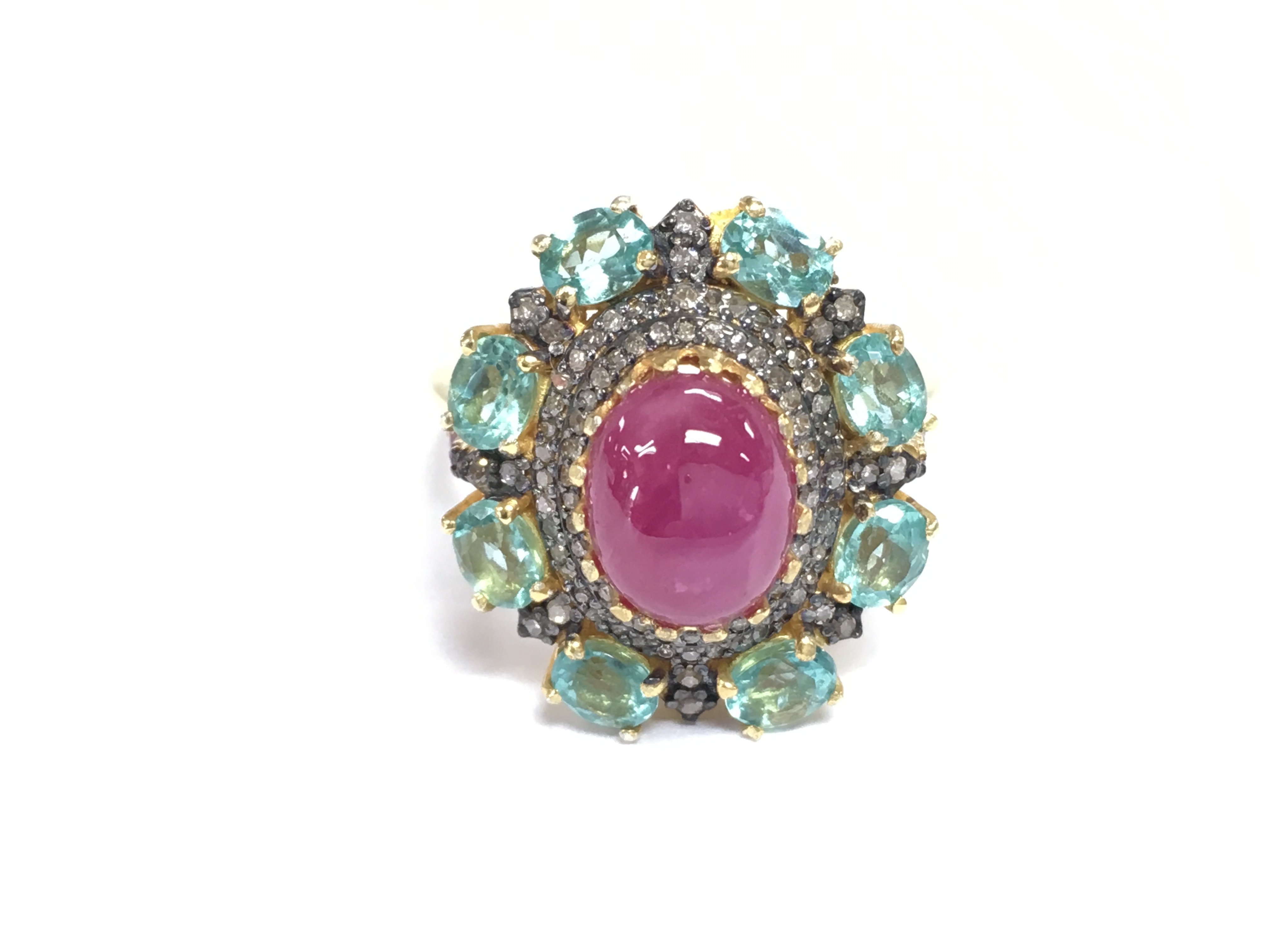 A cabochon ruby heat treated diamond and round green Apatite silver gilt dress ring. Ruby 2.80ct Apatite 3.50ct and Diamonds 0.65ct all approximate. Size P