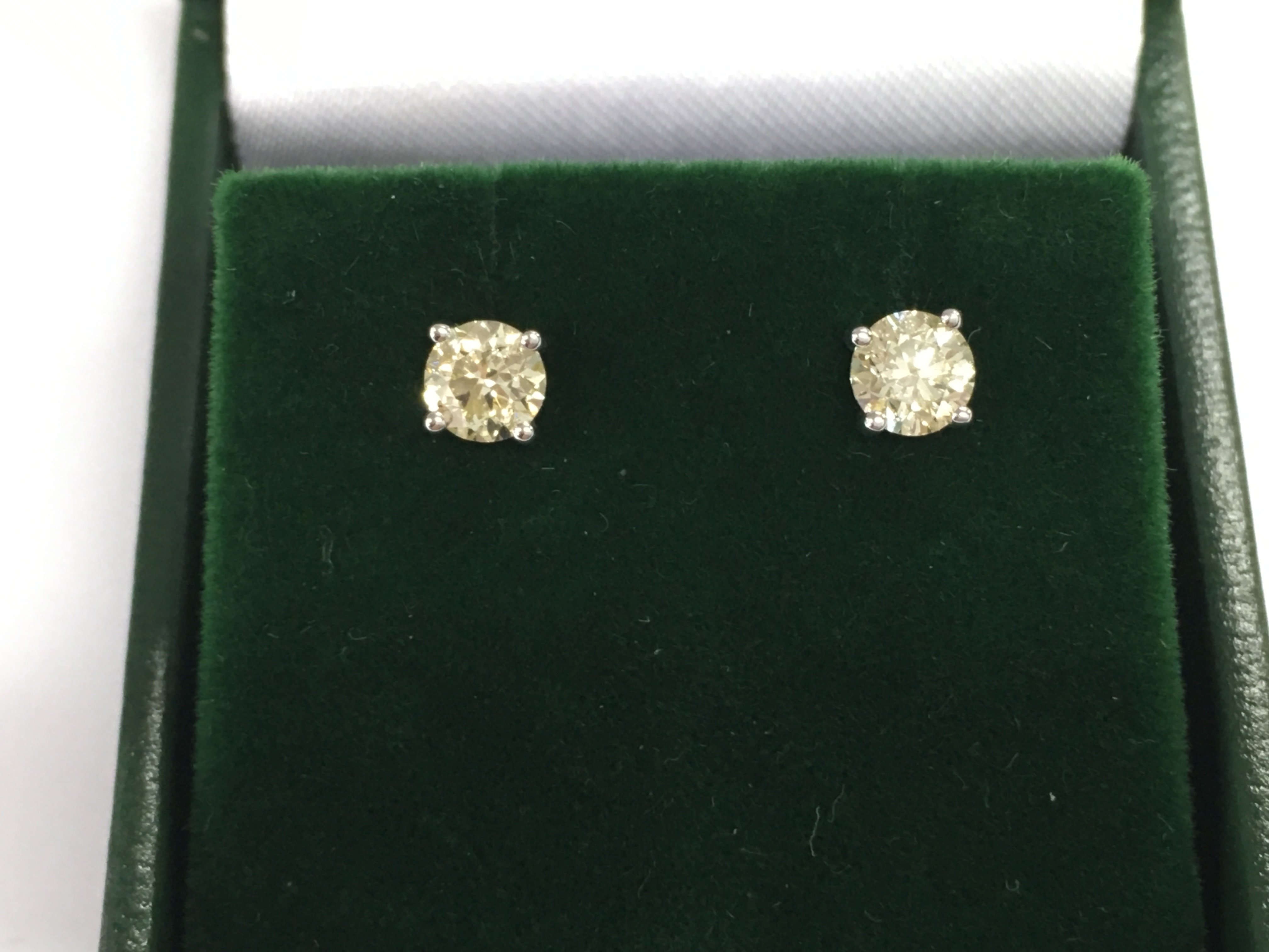 A pair of 18ct white gold diamond solitaire studs. Approx 0.82ct. Postage B