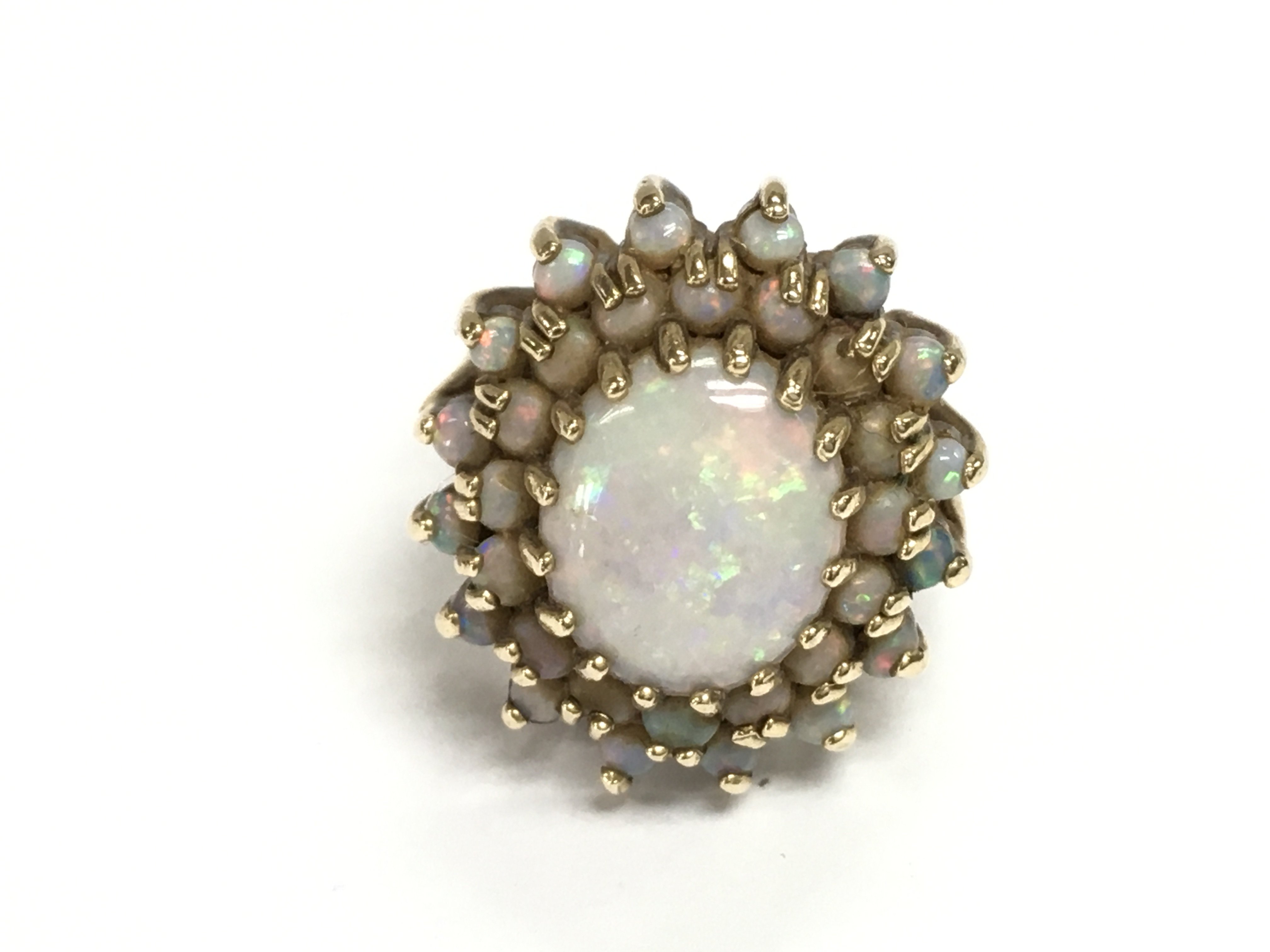 A 9ct gold Opal cluster ring. 6.45g and size M