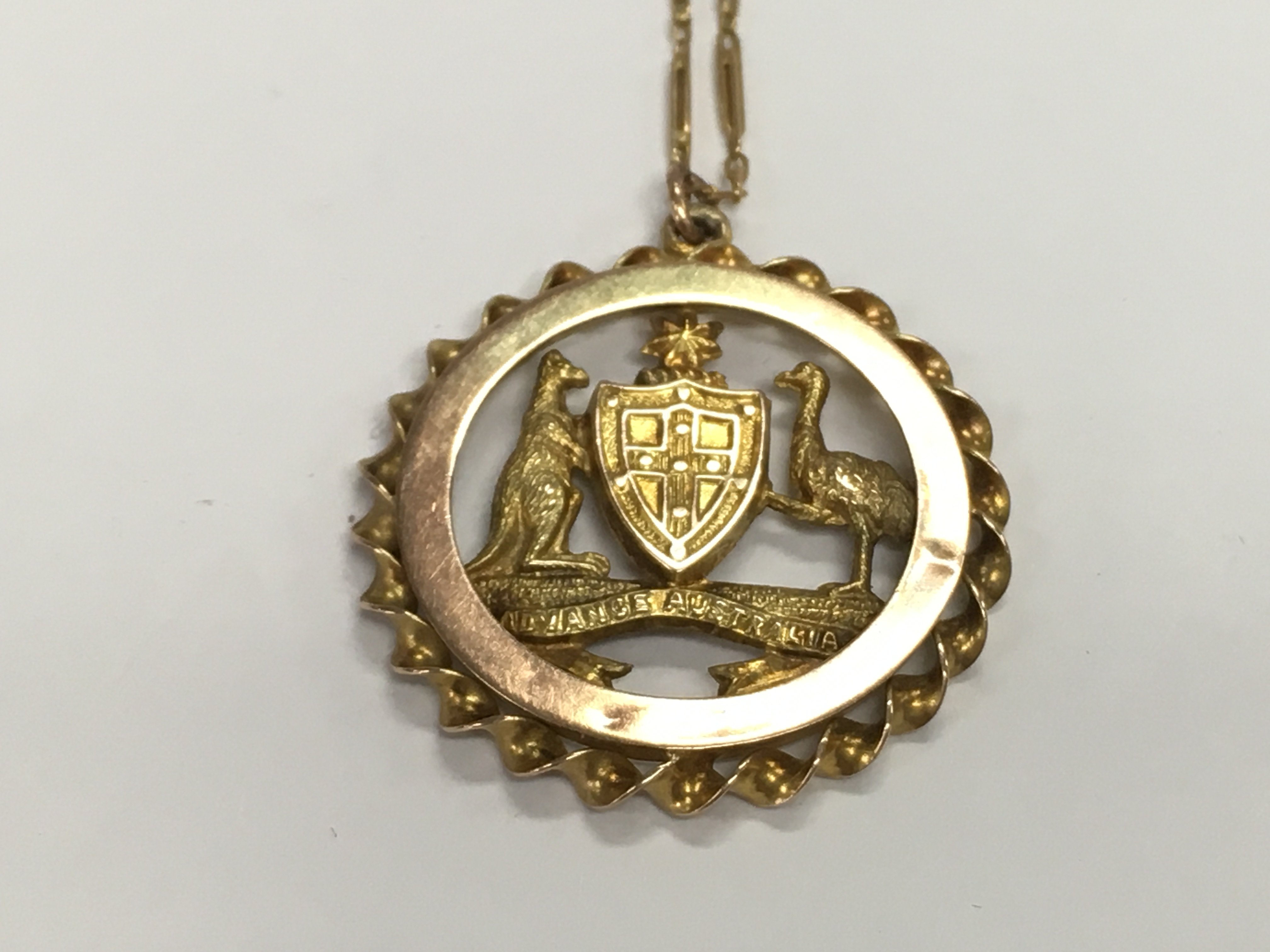 A 15ct gold chain and a 9ct gold pendant. 4.85g