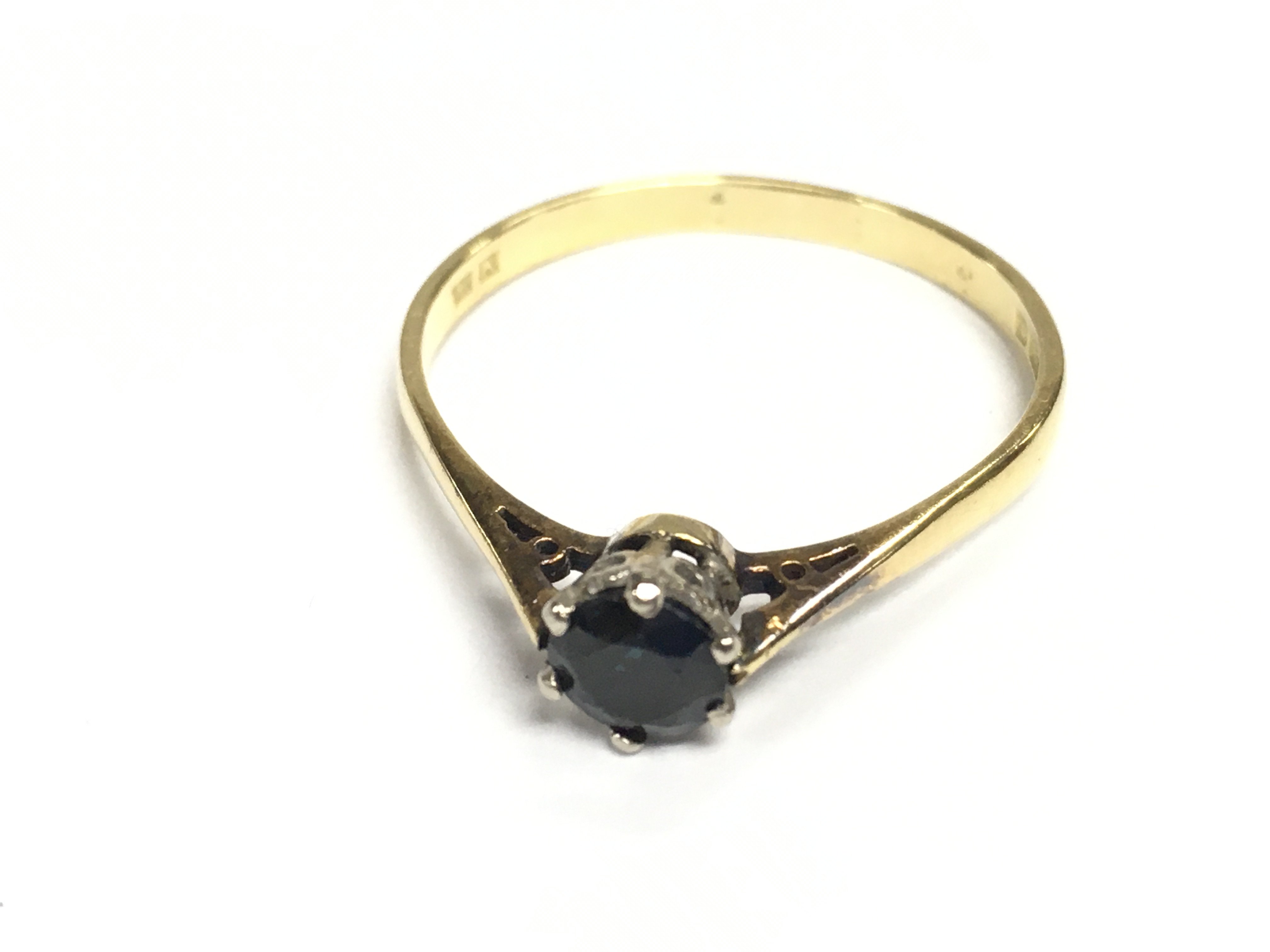 An 18ct gold ring set with a sapphire. Size S 1/2 and 2.26g Approx