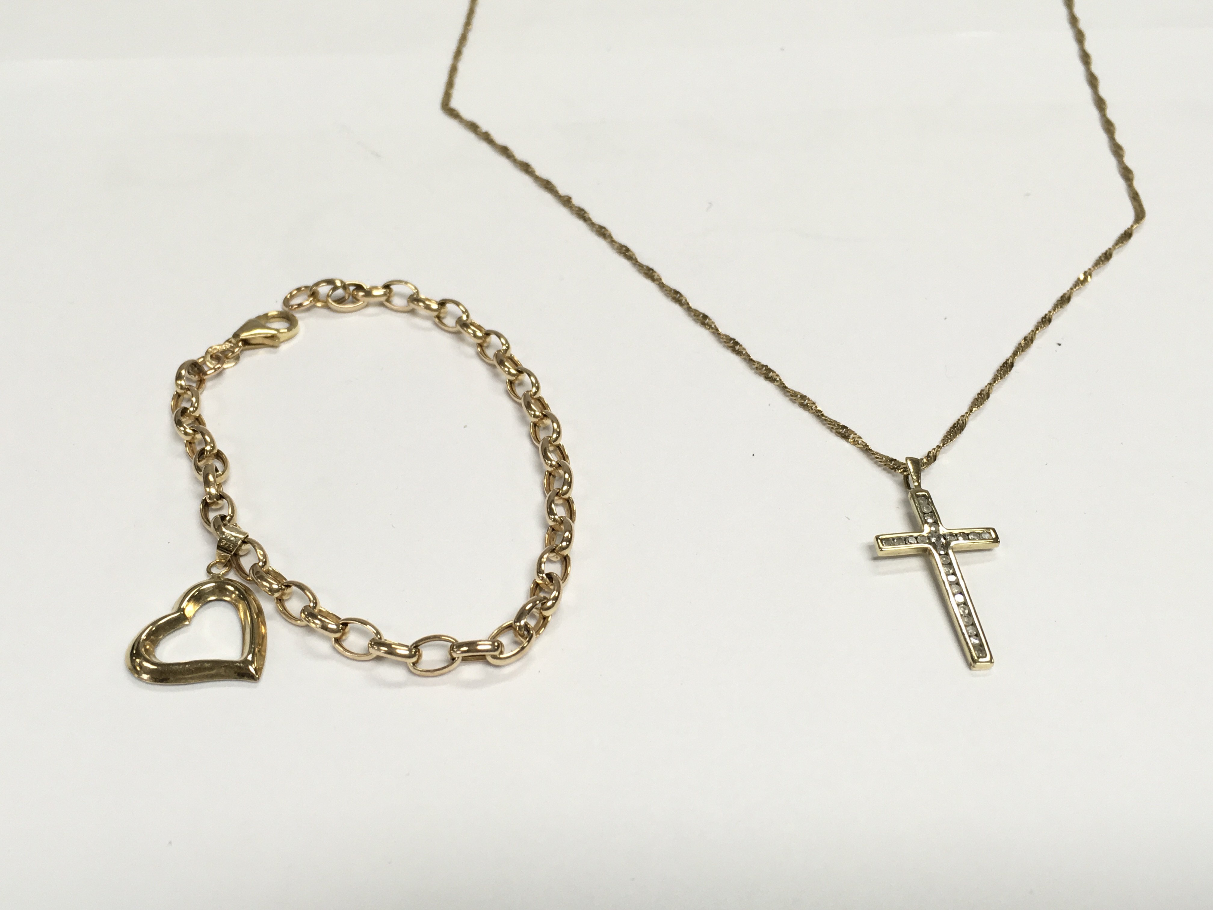 A 9ct gold bracelet along with a 9ct gold chain and a yellow metal cross pendant. 6.15g Postage A