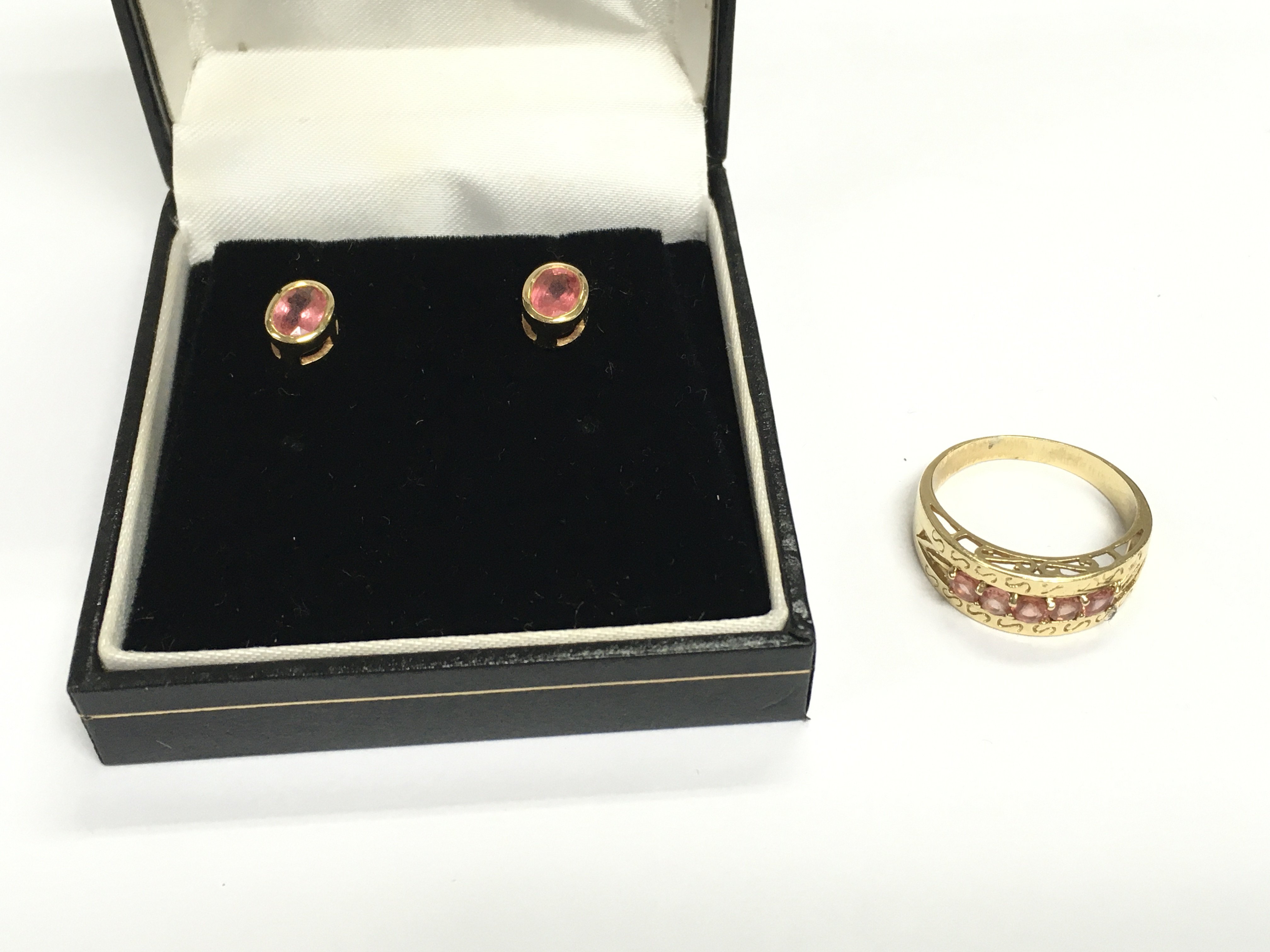 An 18ct gold ring set with pink stones size R and 5.17g and matching earrings.