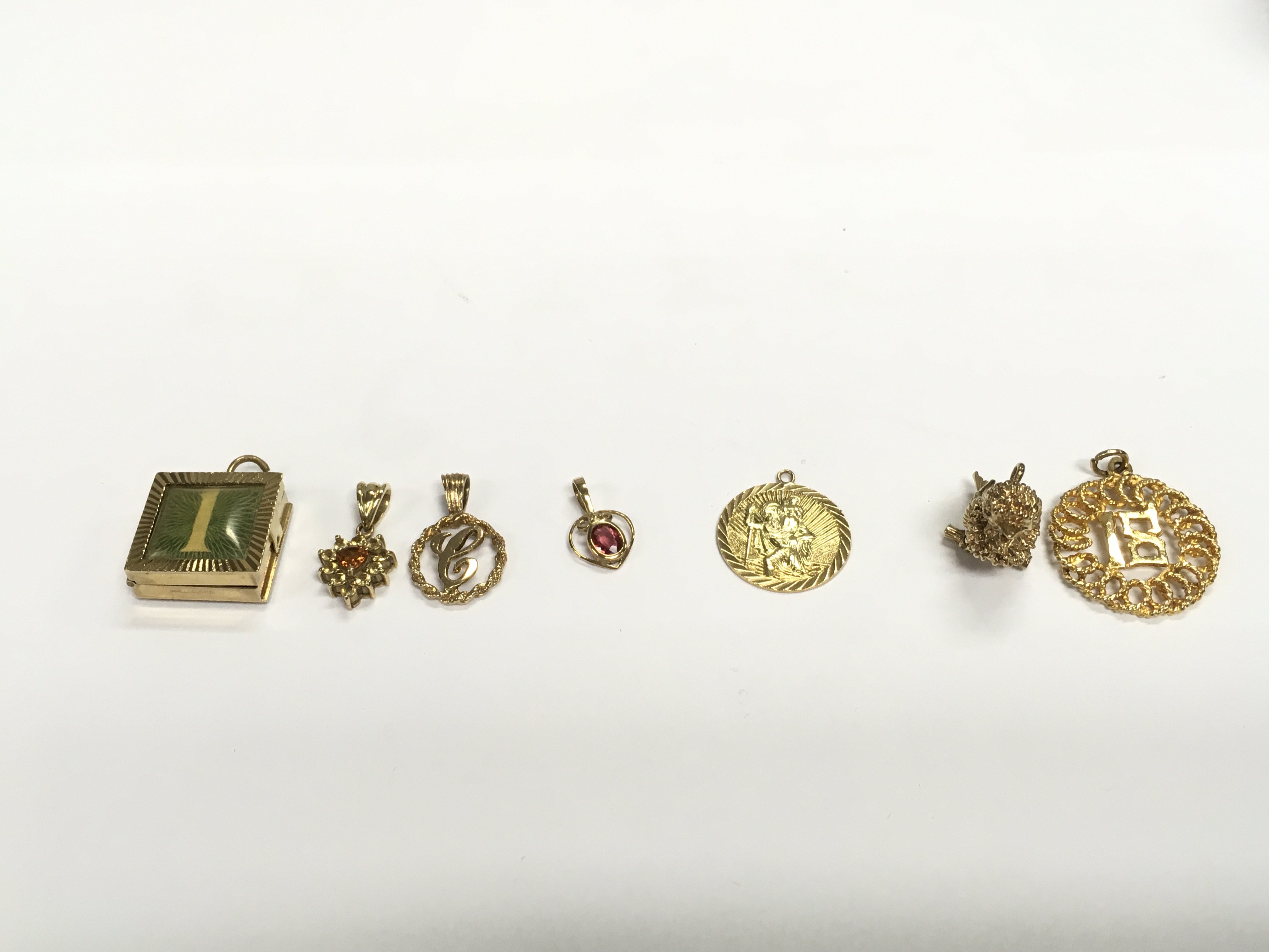 A collection of 9ct charms and pendants. 18.03g Postage A