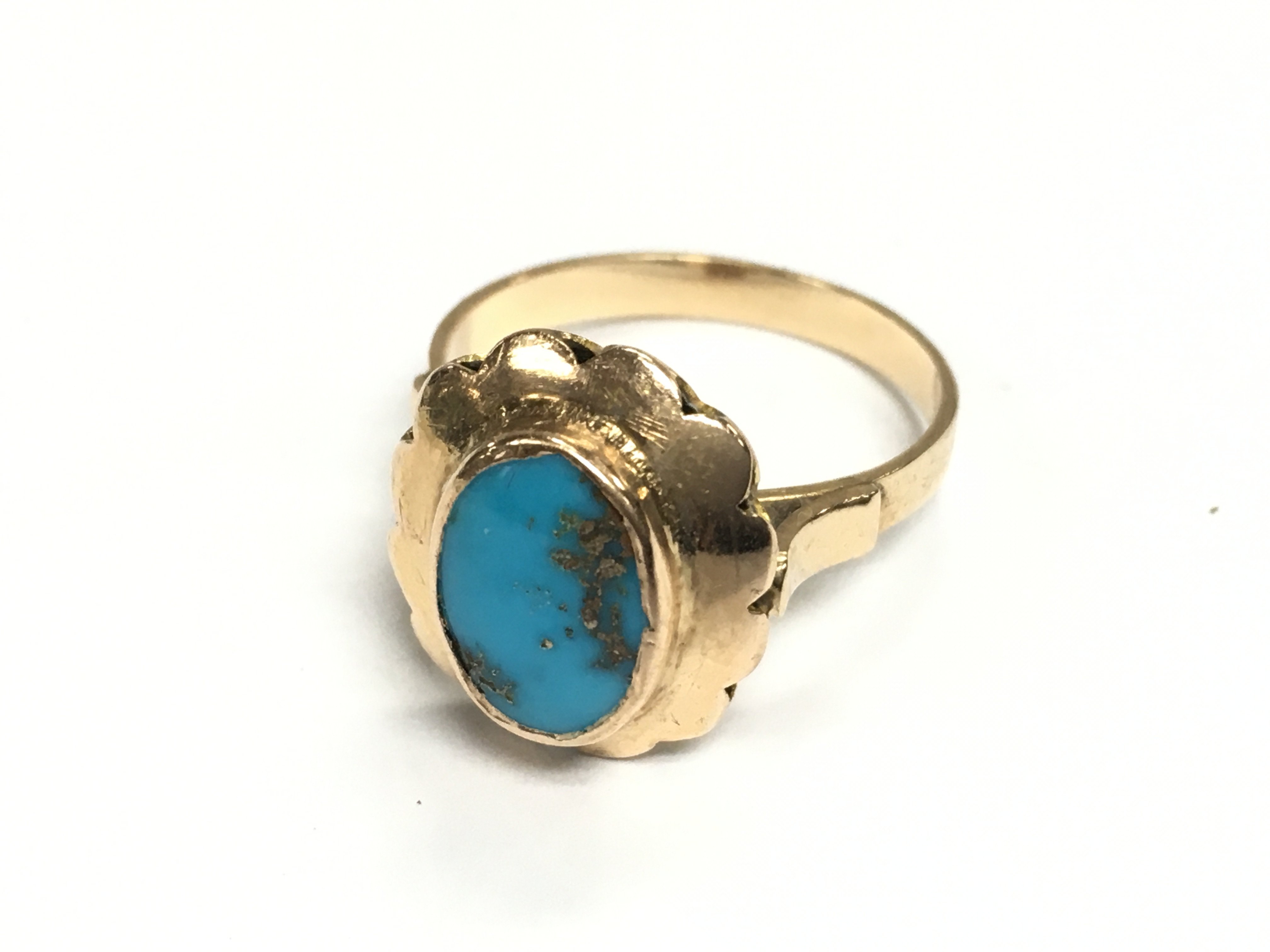 An unmarked gold ring set with turquoise. 3.61g and size O