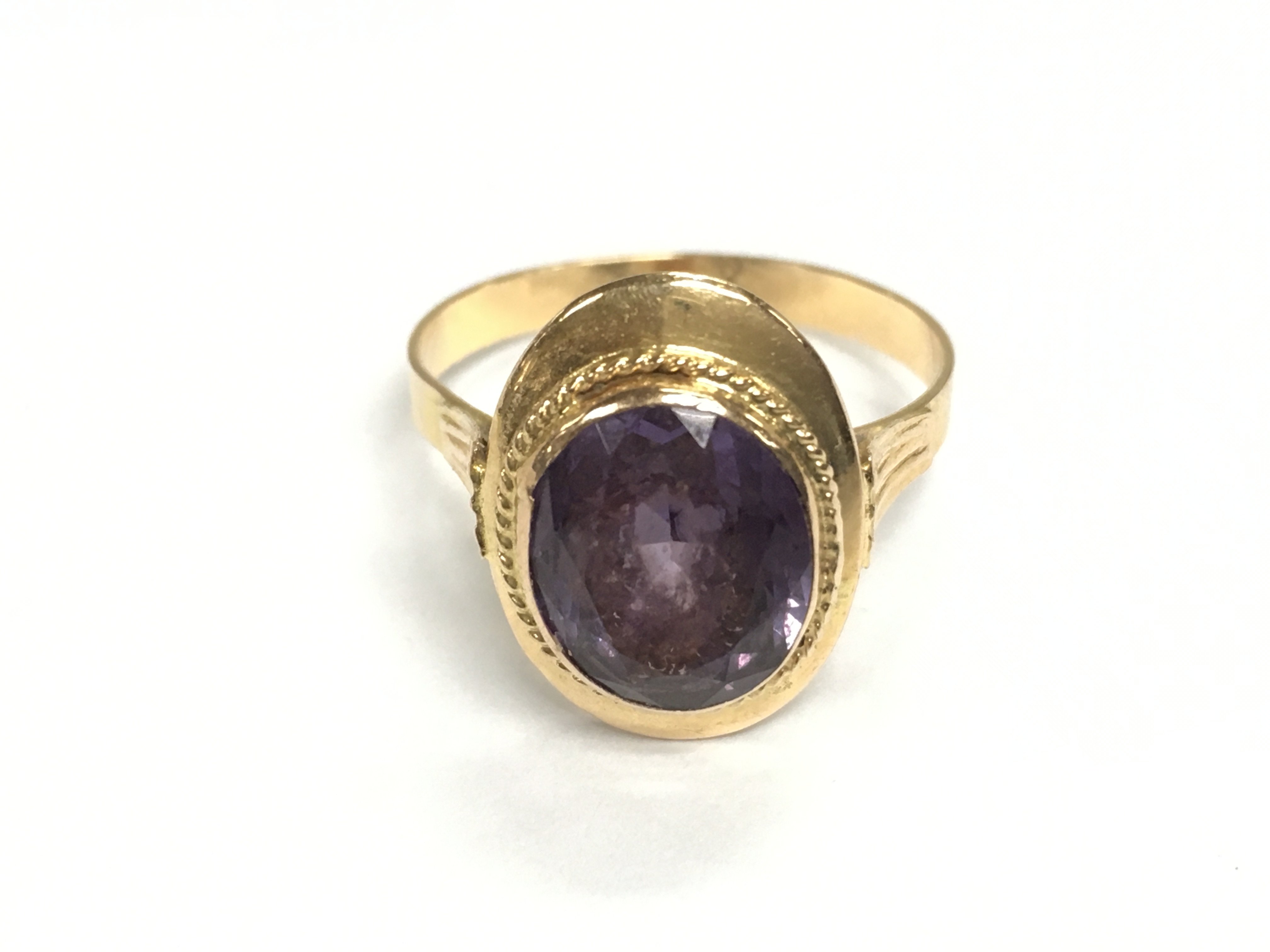 An unmarked gold ring set with amethyst. Size Q and 3.31g