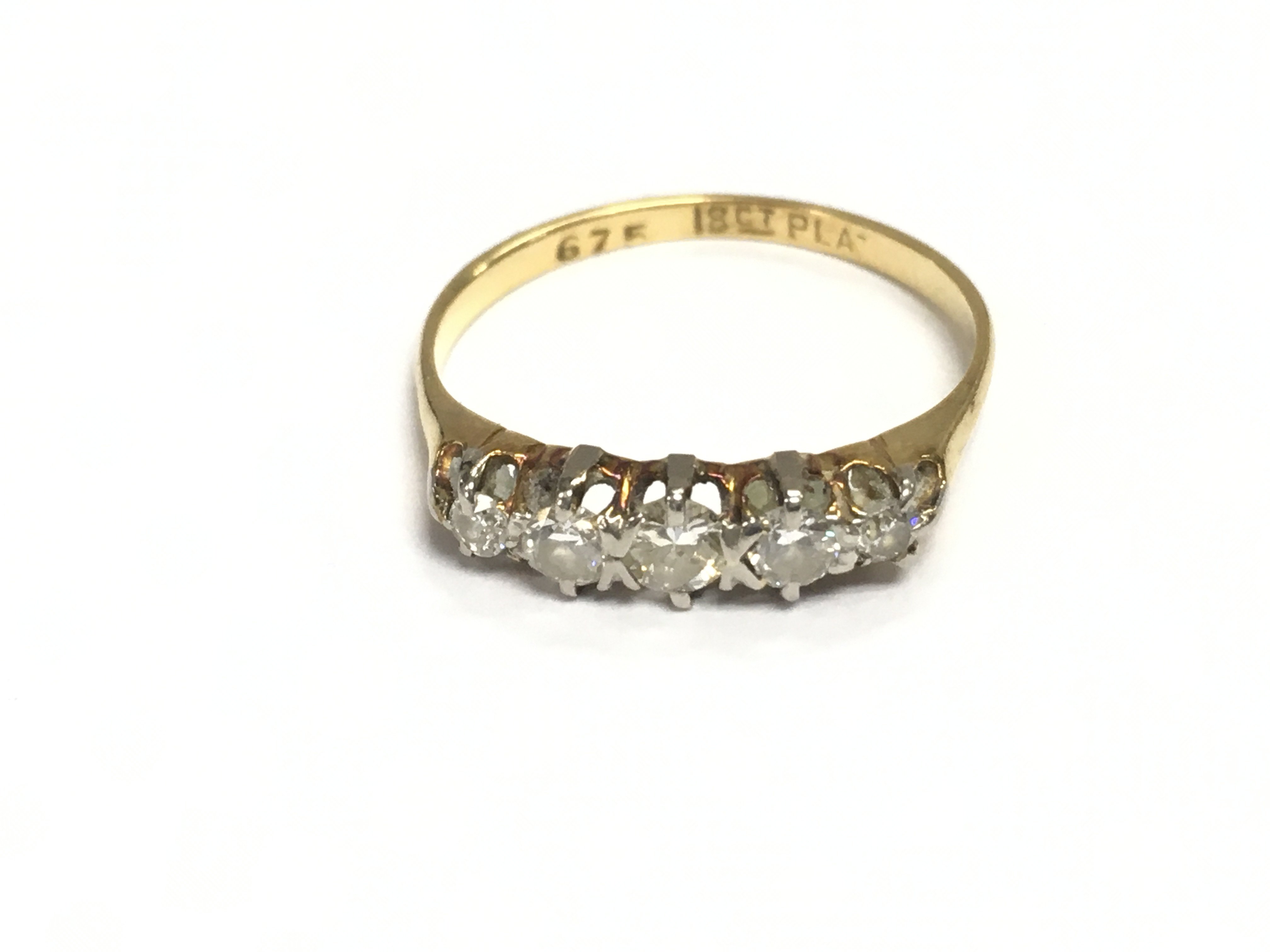 An 18ct gold ring set with a diamonds. Size N and 2.03g