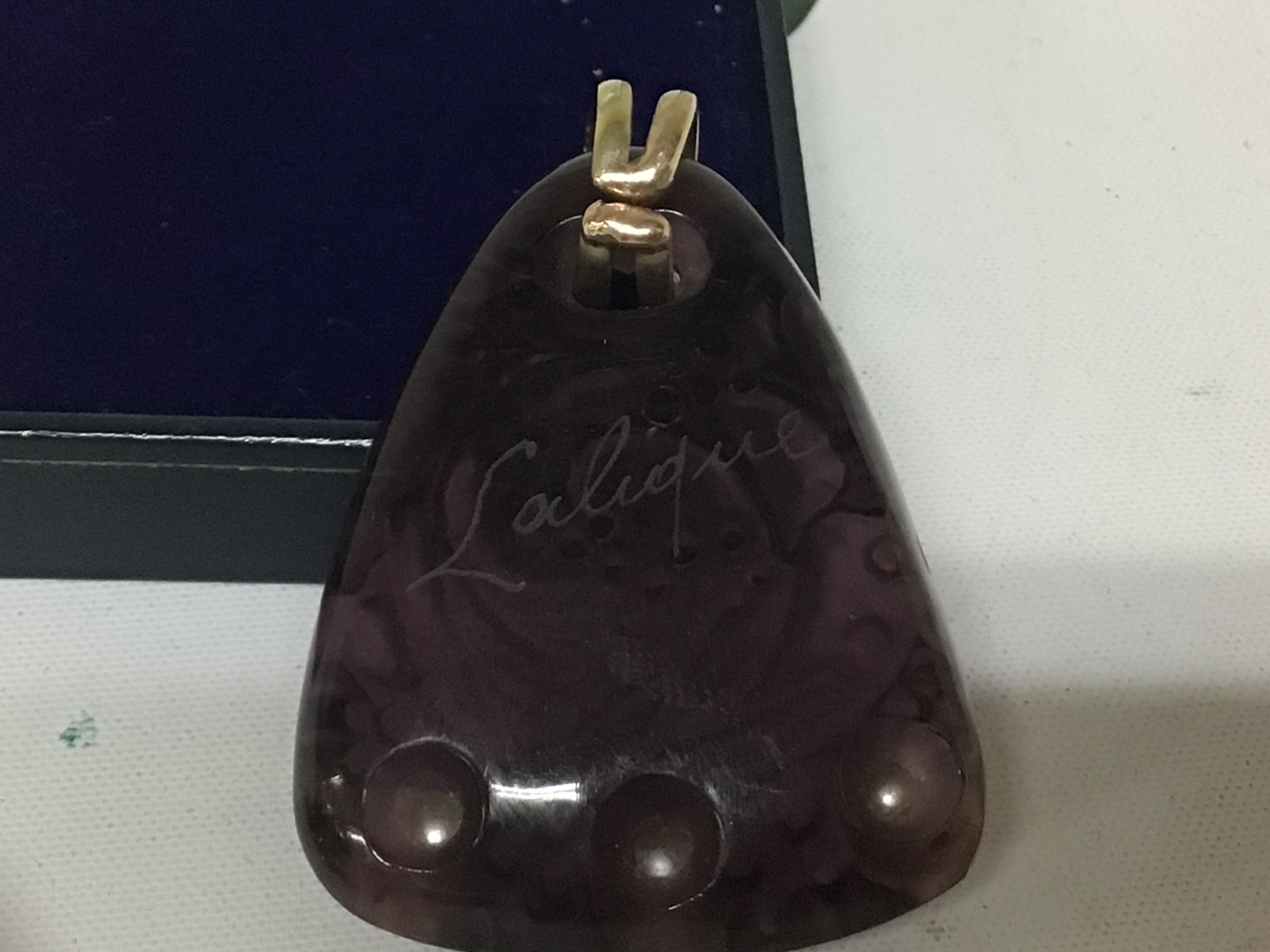 A Lalique glass pendent set with three pearls the reverse signed Lalique 5cmx3.8cm approximately.