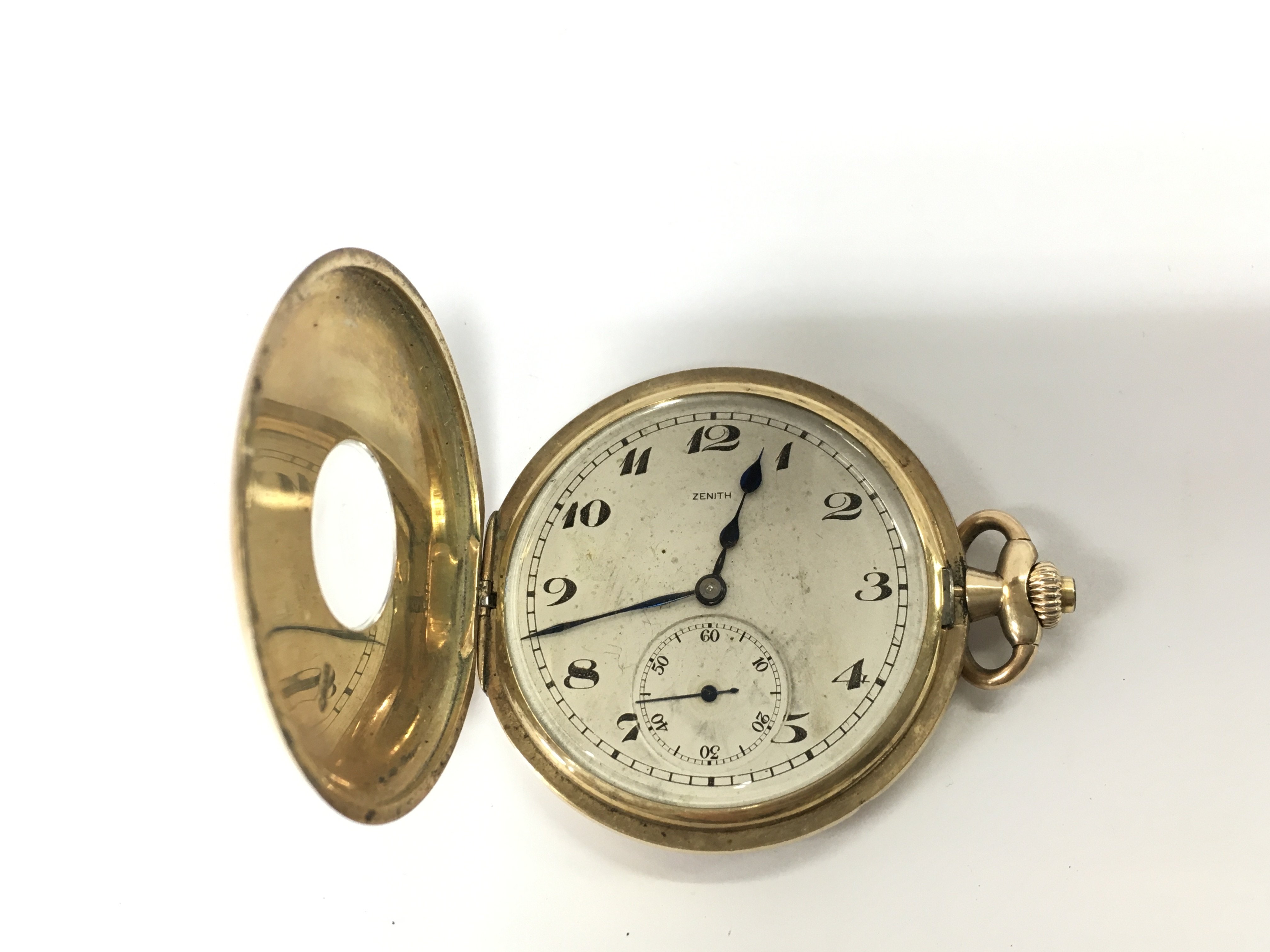 A 9ct gold Zenith half hunter pocket watch. Approximately 48mm case and 64.66g. Winds and seen running.
