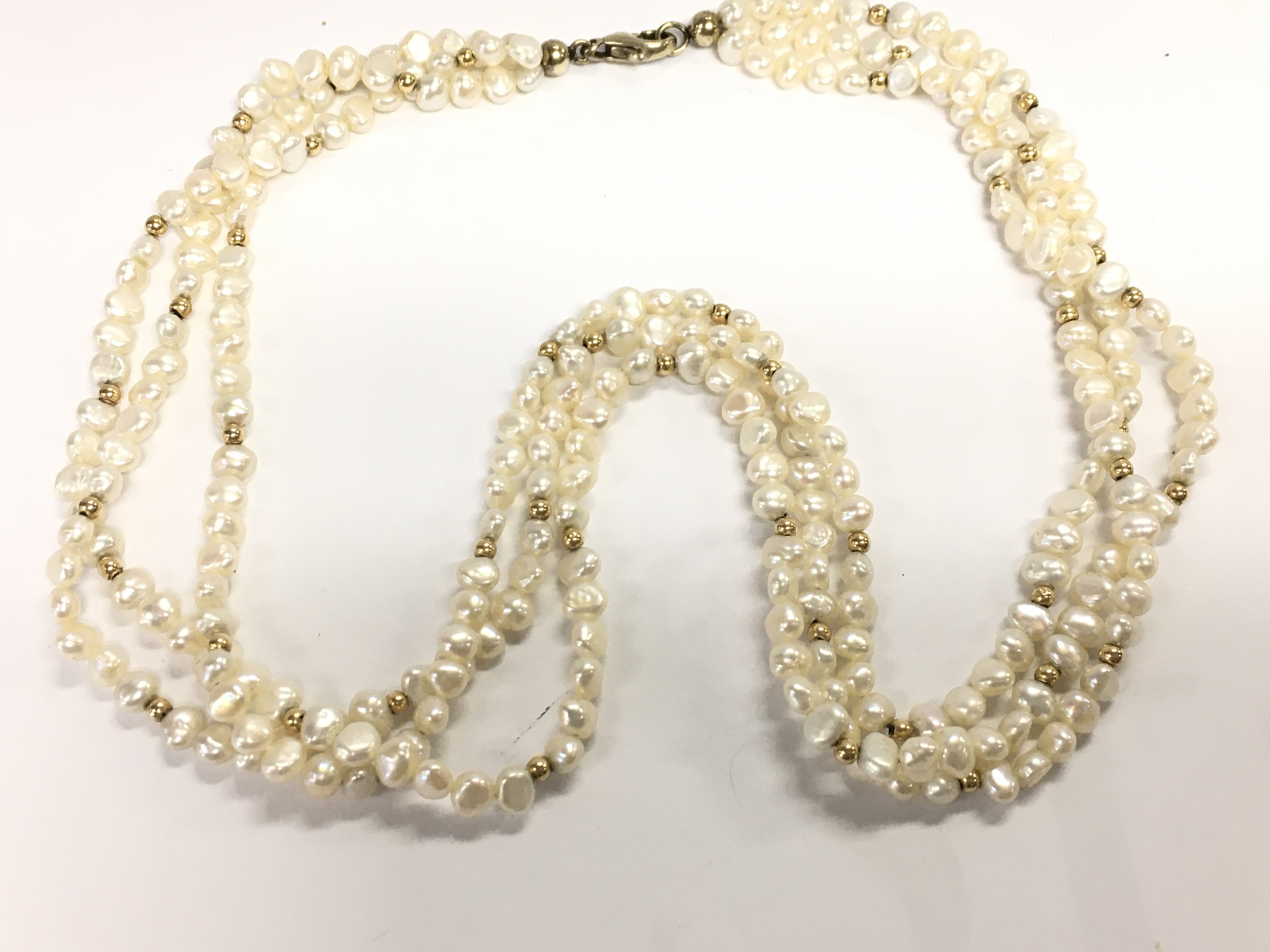 A three string pearl necklace. Approximately 47cm length. Postage A. NO RESERVE