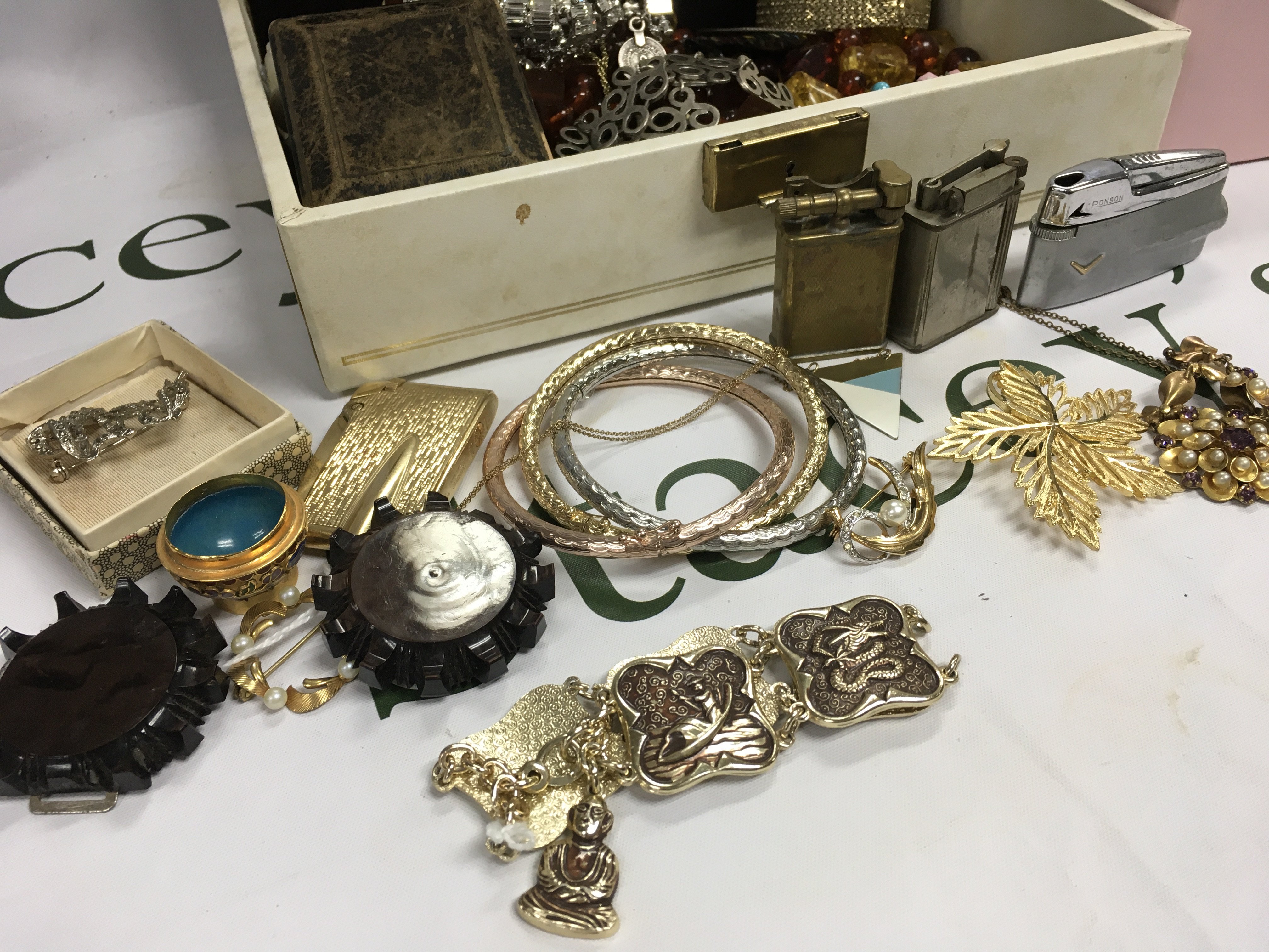 Two boxes of costume Jewellery including a marcasite brooch, lighters, silver case, bakelite necklace, Necklaces etc postage category B