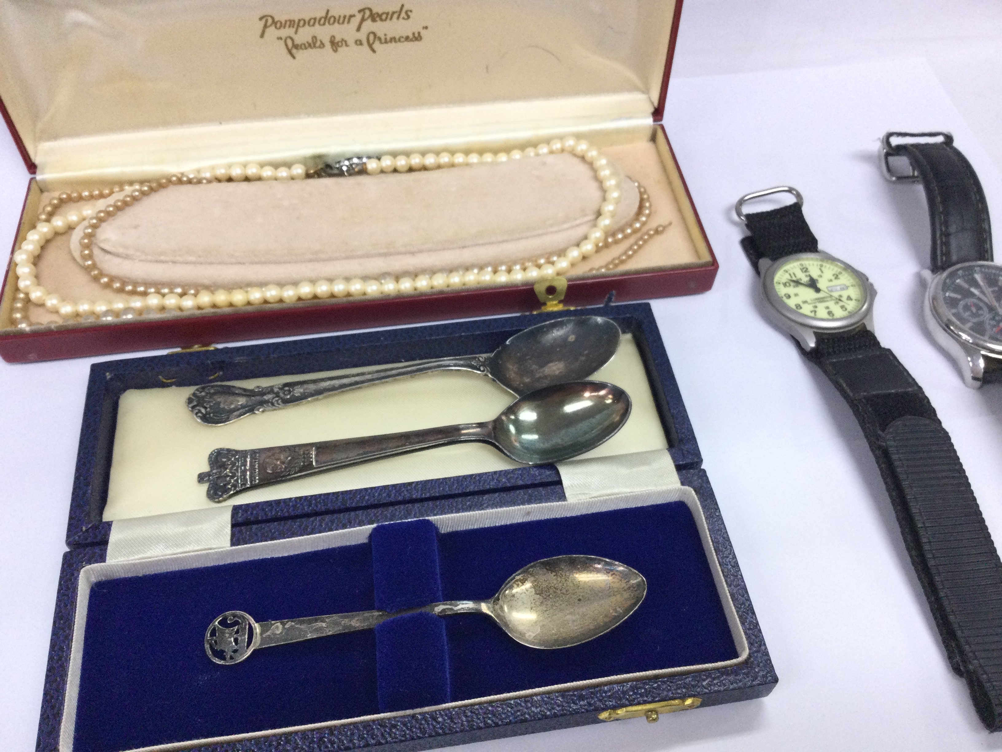 A collective lot including simulated pearls watches and spoons including silver and silver plate.