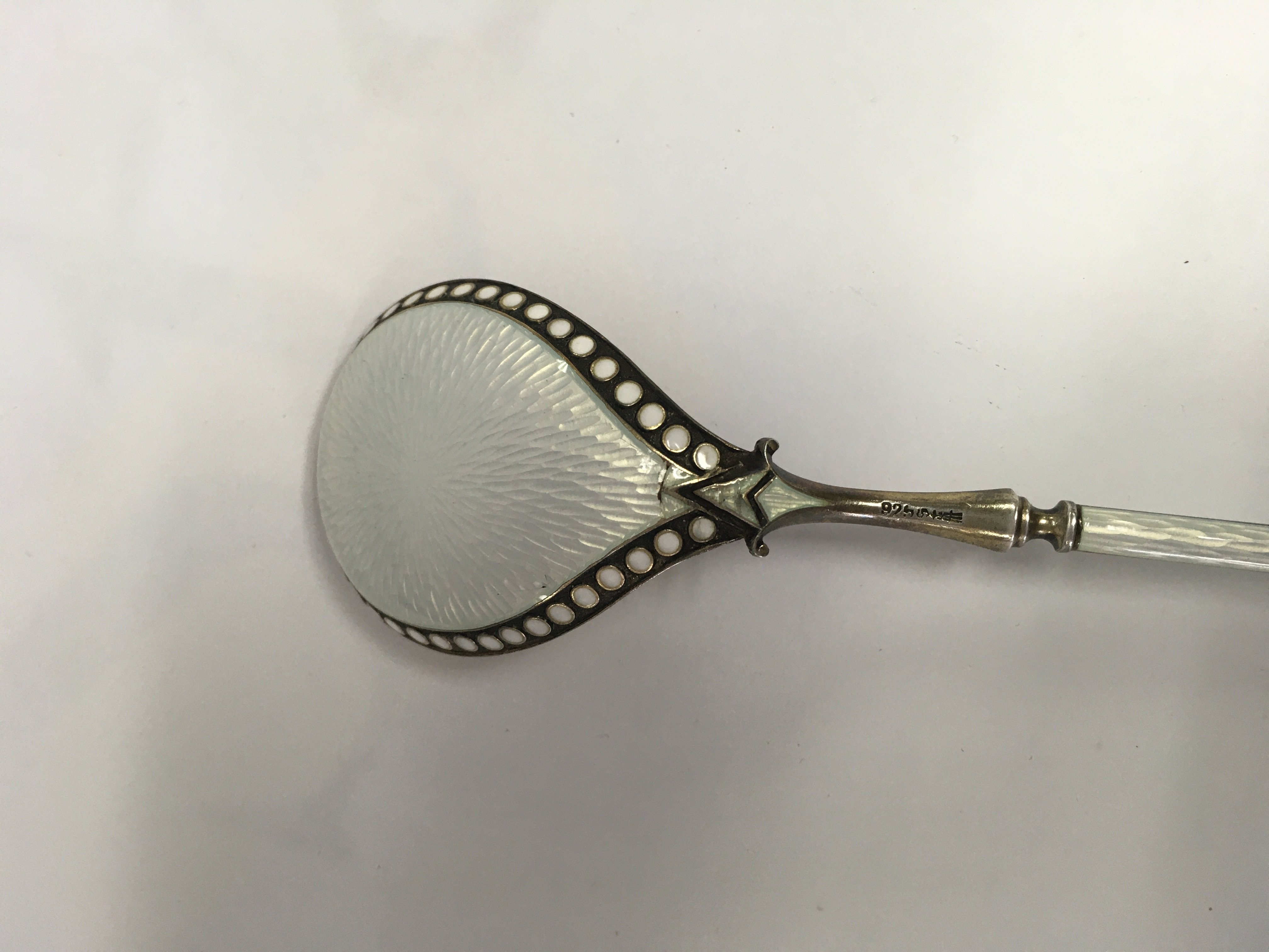 A silver and enamel spoon with tapering handle . NO RESERVE