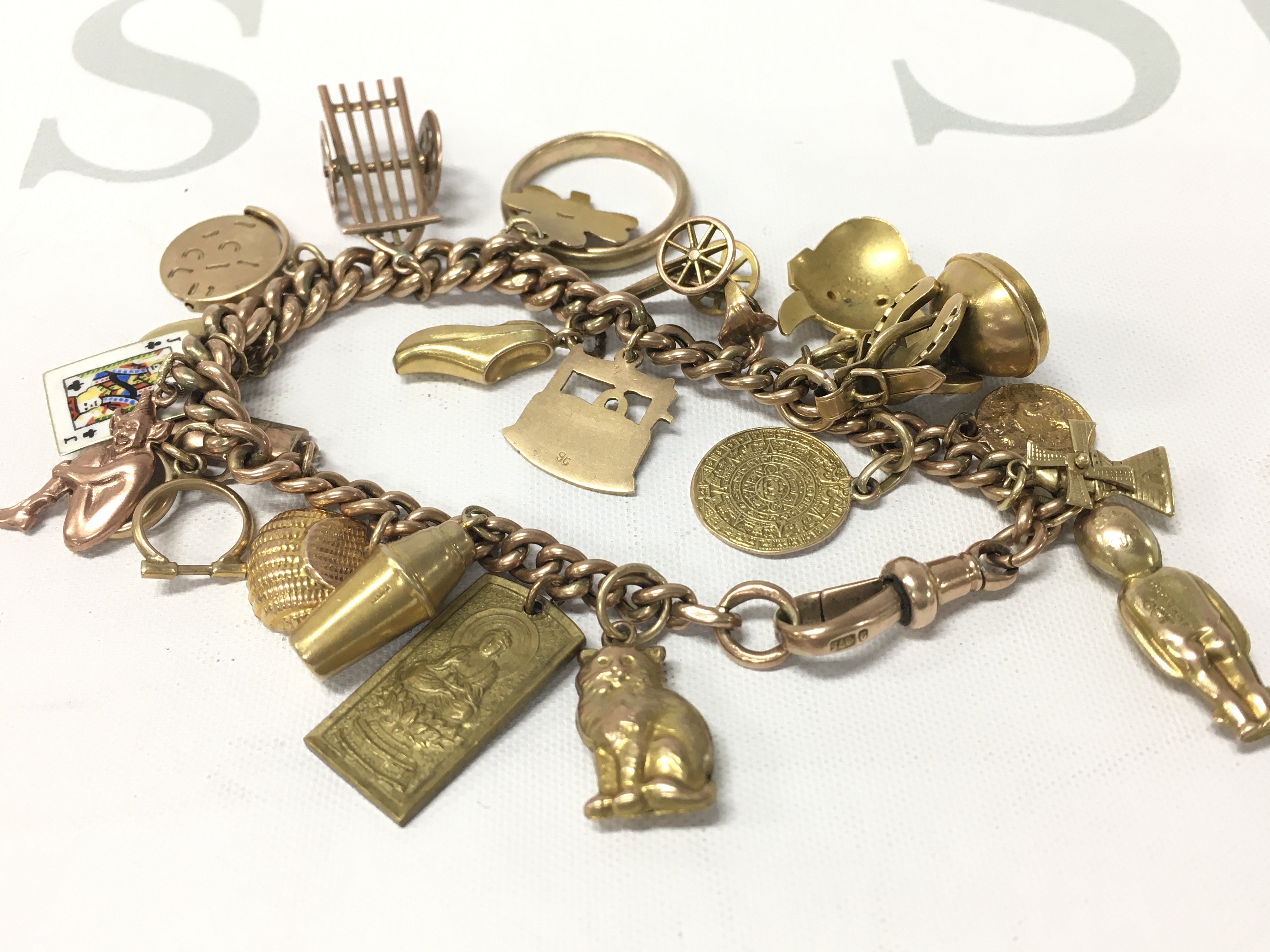 A 9ct gold charm bracelet with mixed charms. Approx weight 39.02 grams.