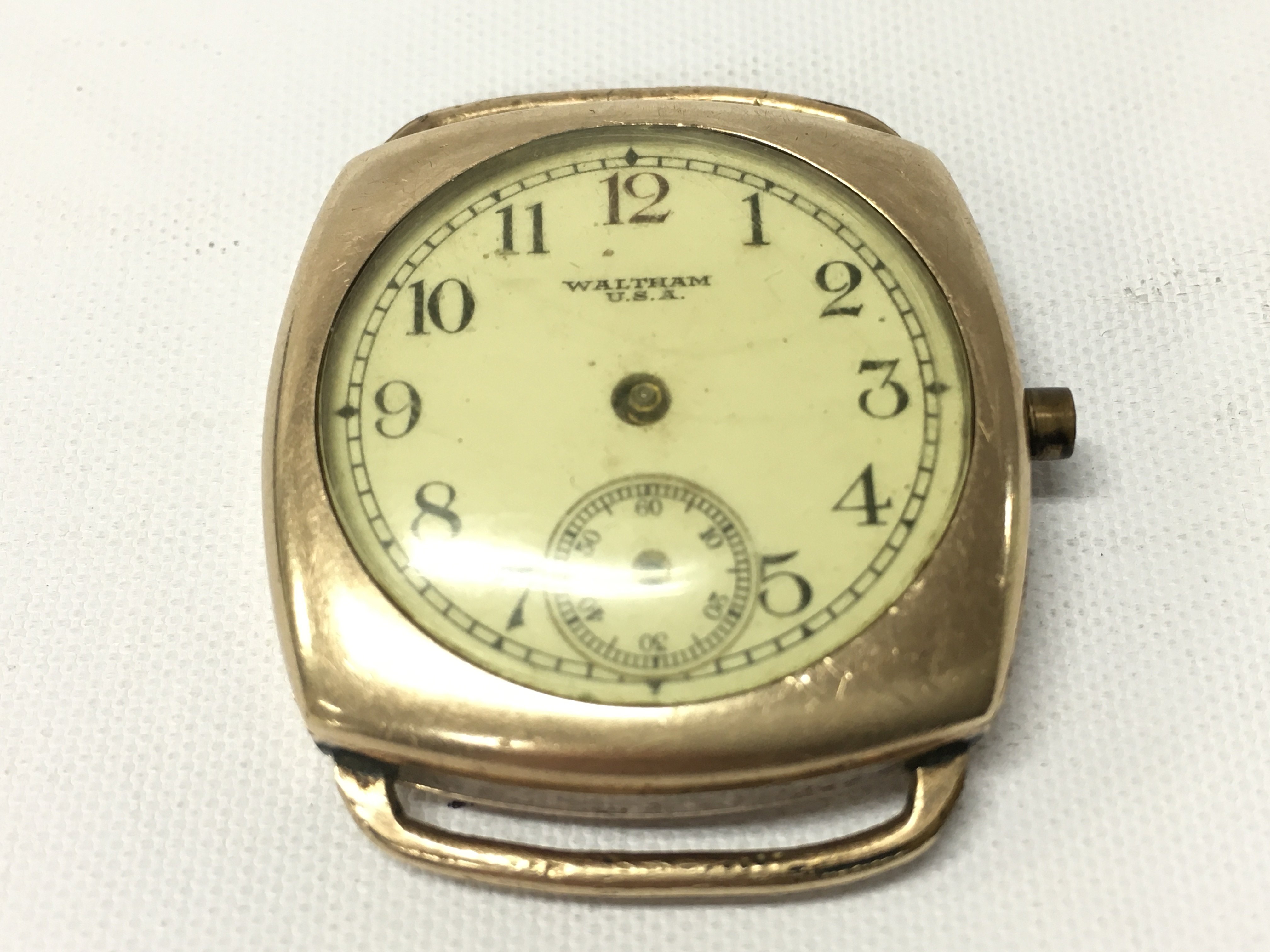 A yellow metal unmarked cased Waltham wristwatch.