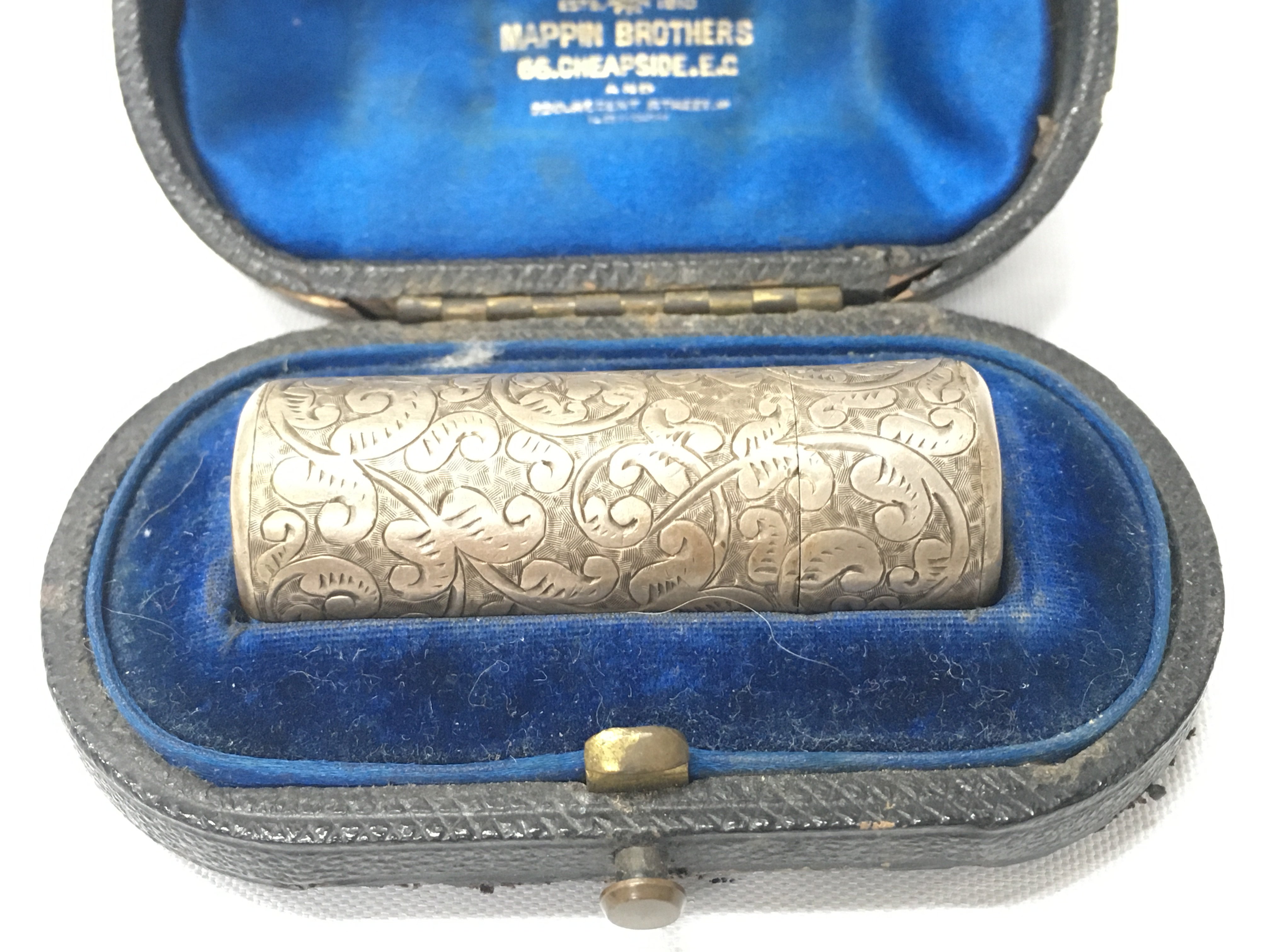 A silver hallmarked perfume case.
