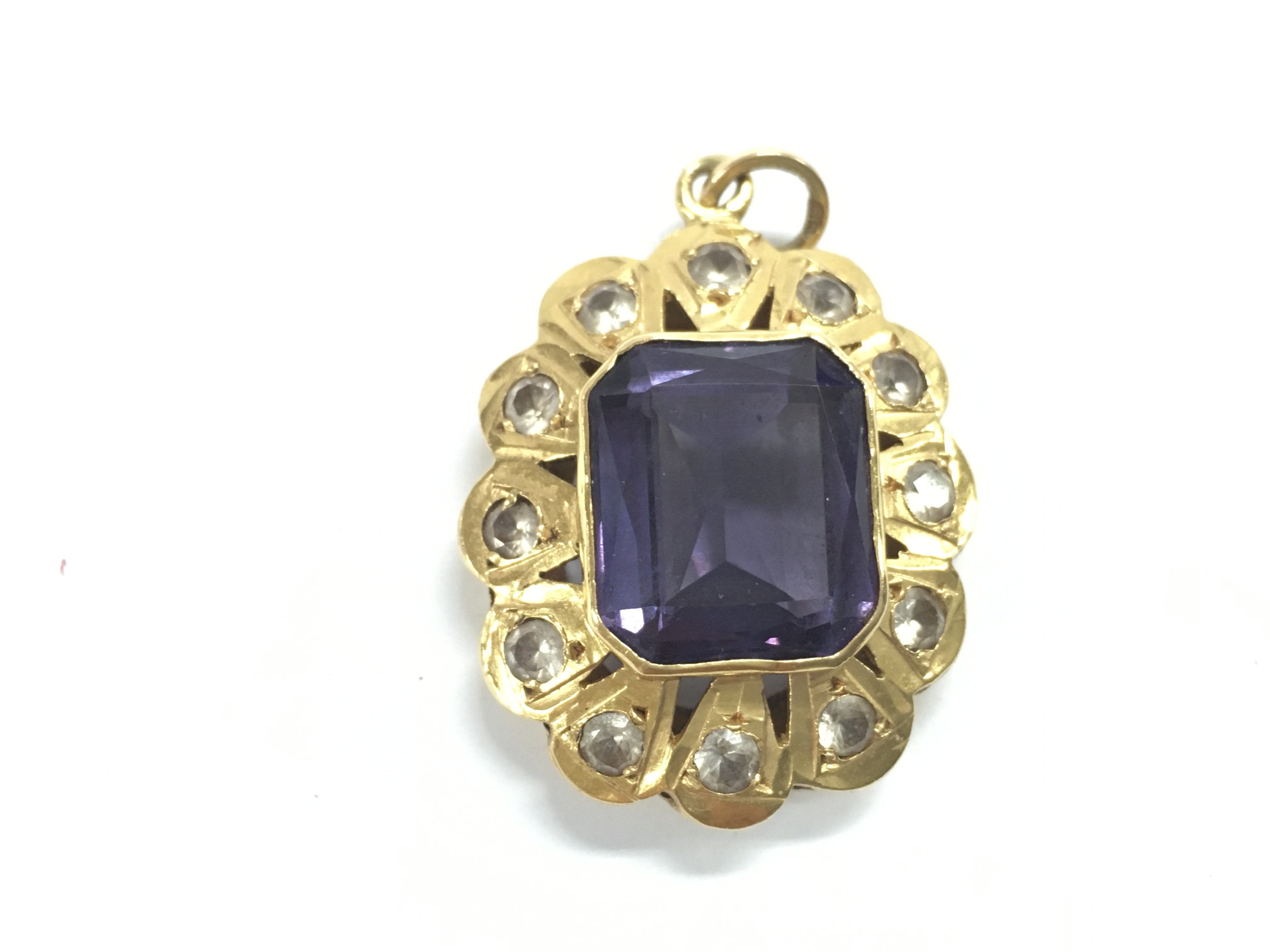 A Middle Eastern gold pendant set with an amethyst. 7.16g