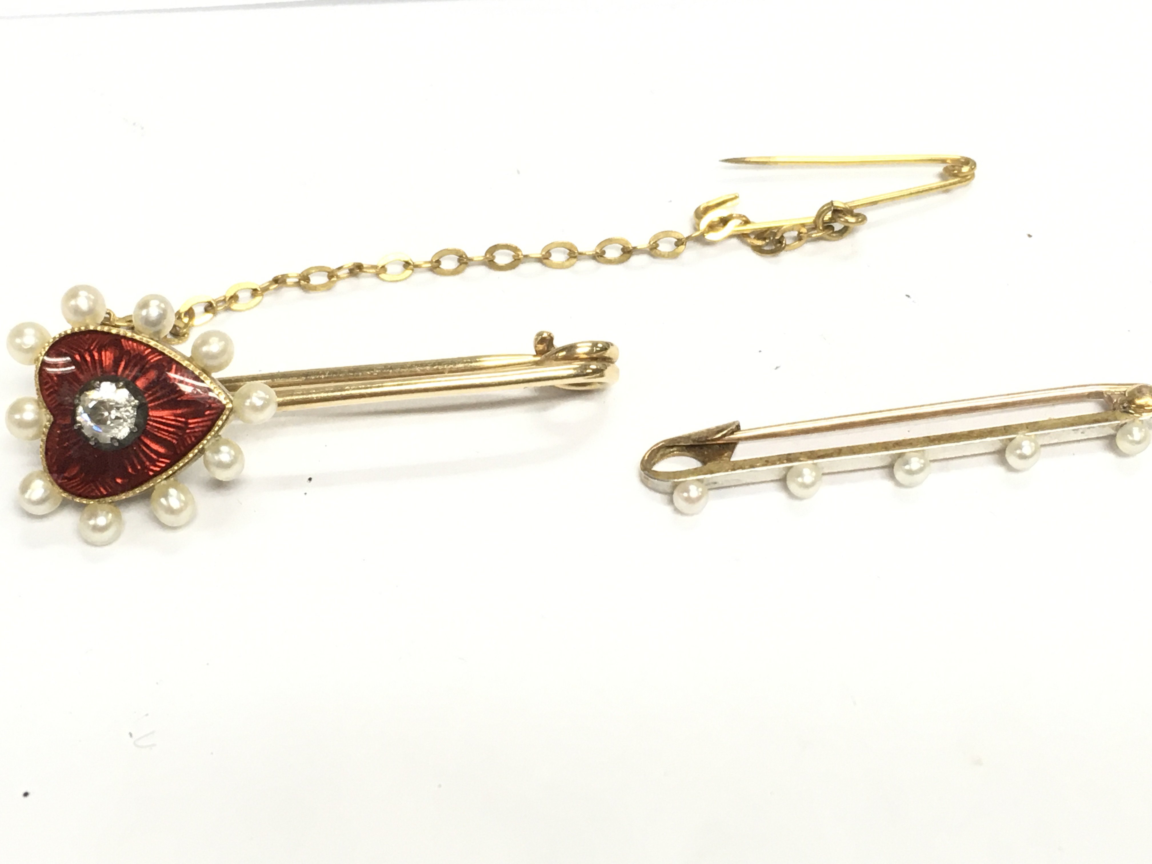 An enamel and pearl brooch and a 14ct gold and platinum pearl brooch. Postage A