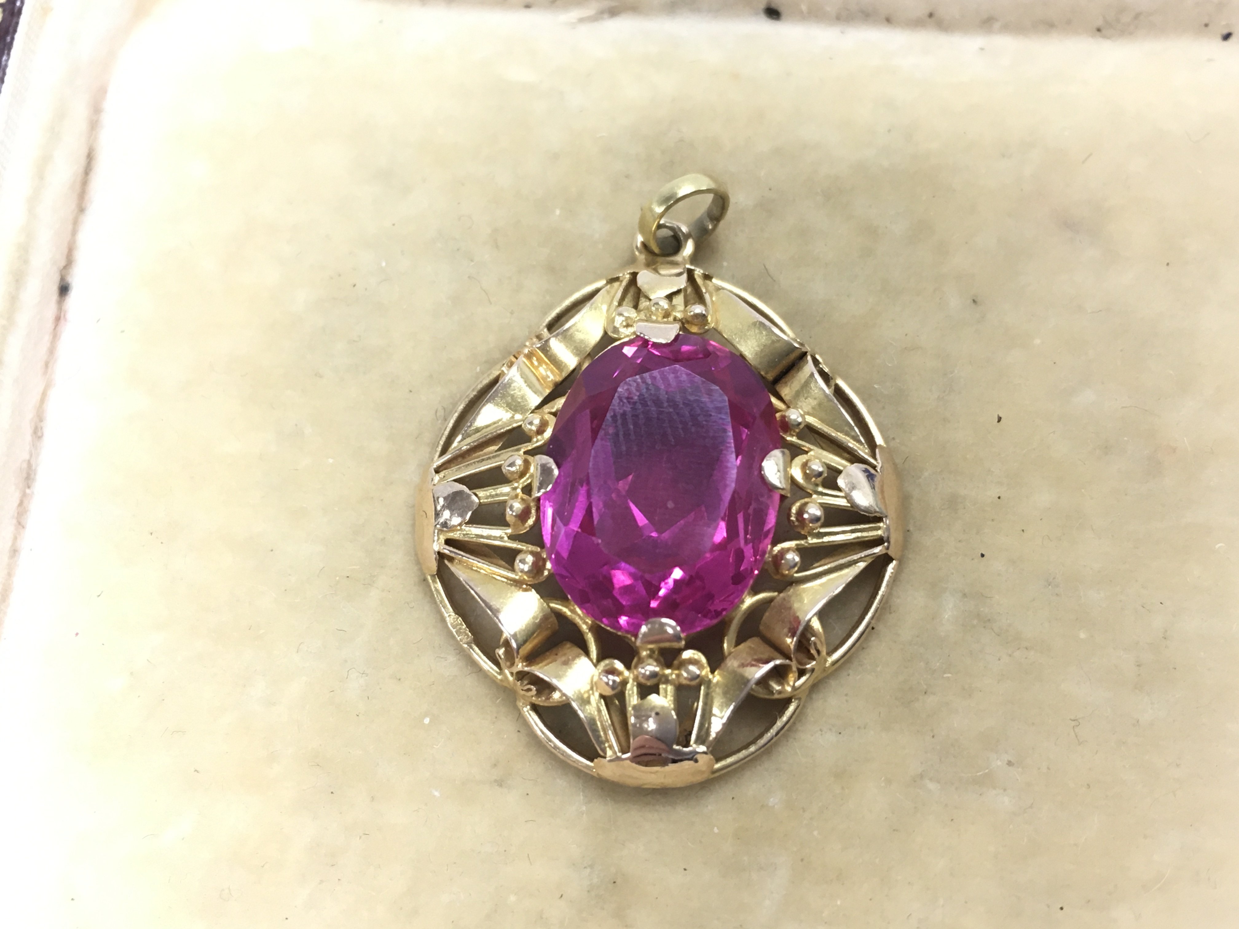 A pink stone pendant . Postage category A