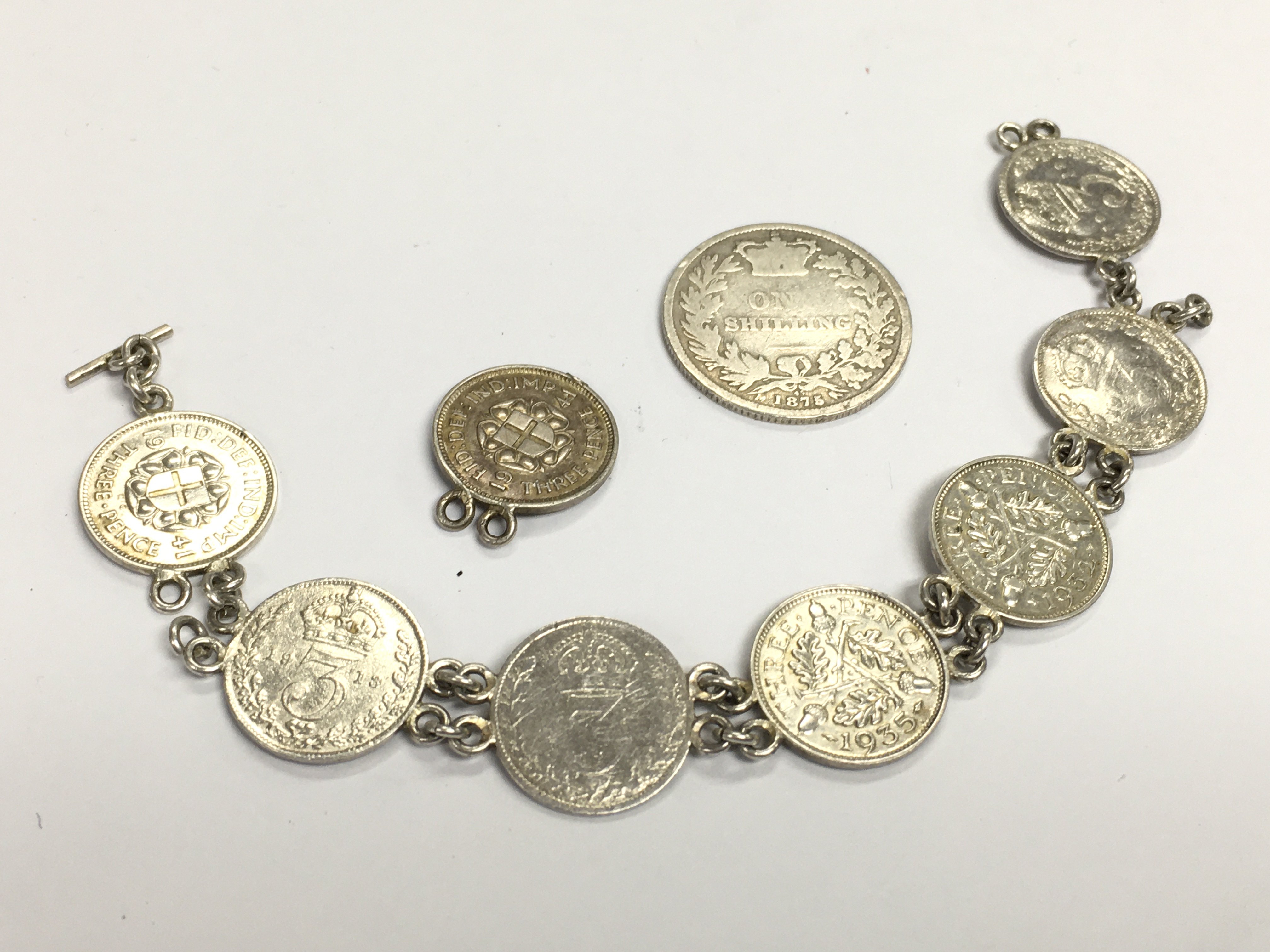 Silver coin bracelet and a Victorian 1875 one shilling. Postage category A