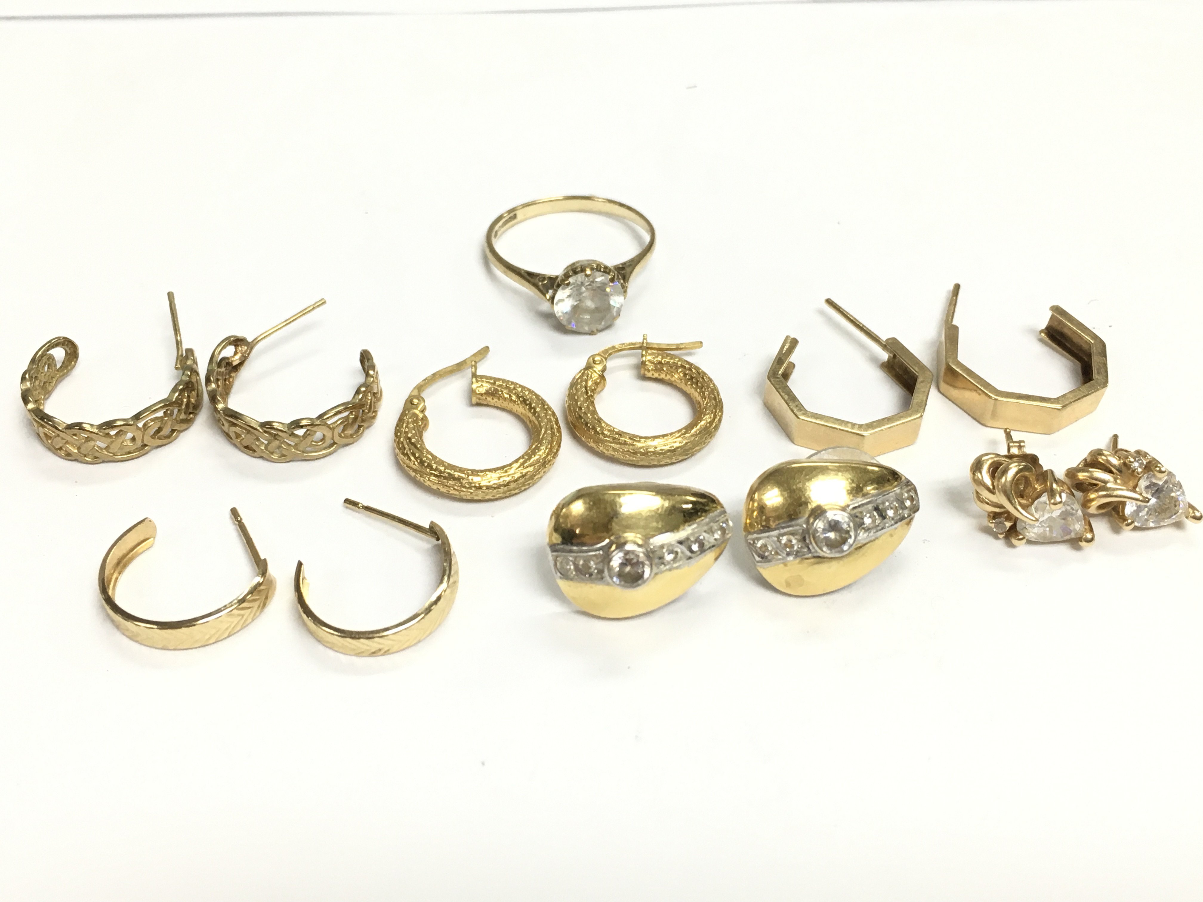A collection of 9 carat gold earrings and a ring. 13g total weight. Postage category A