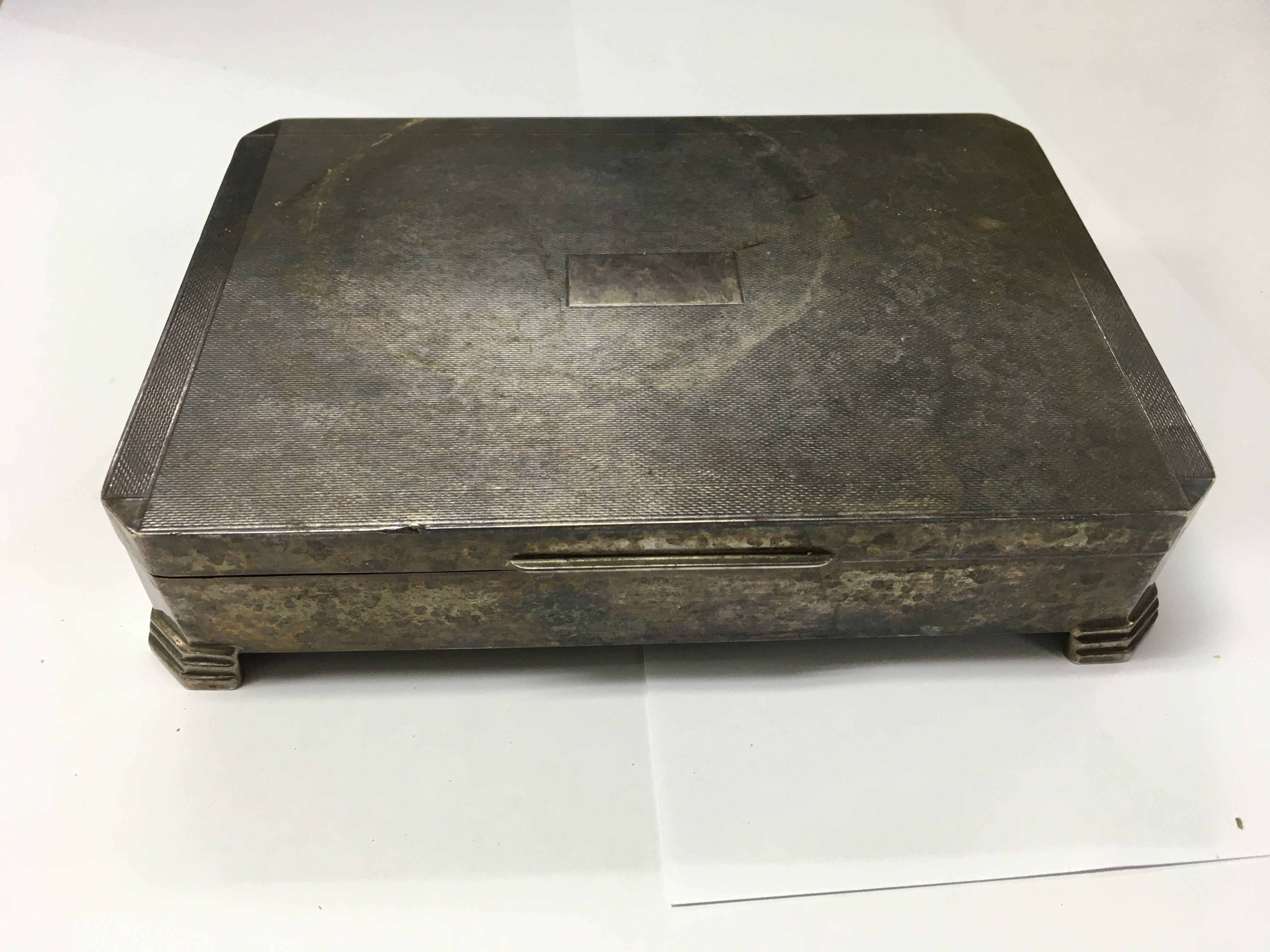 A silver tabletop cigarette box.