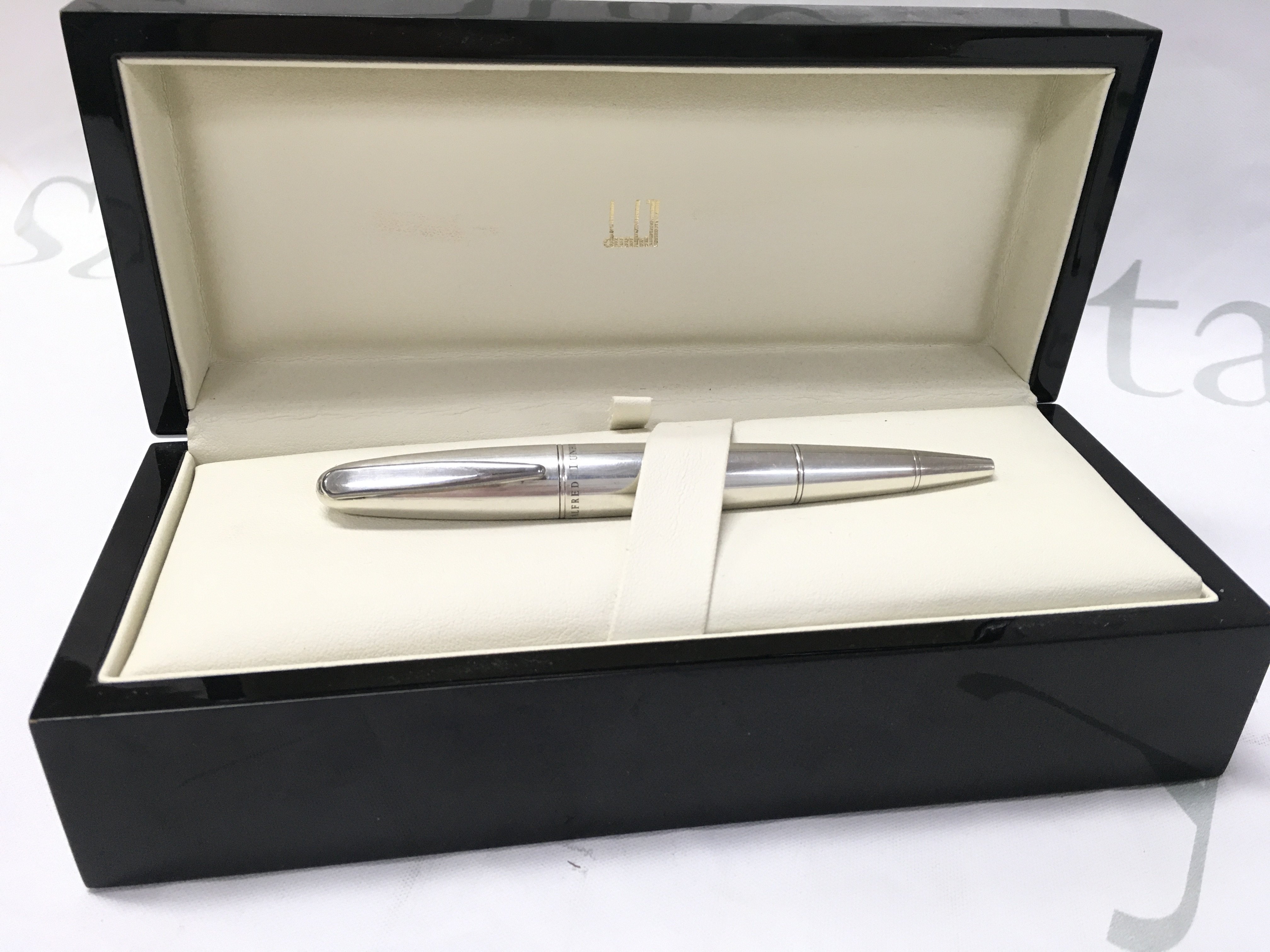 An Alfred Dunhill silver torpedo dual pen and cigar puncher.