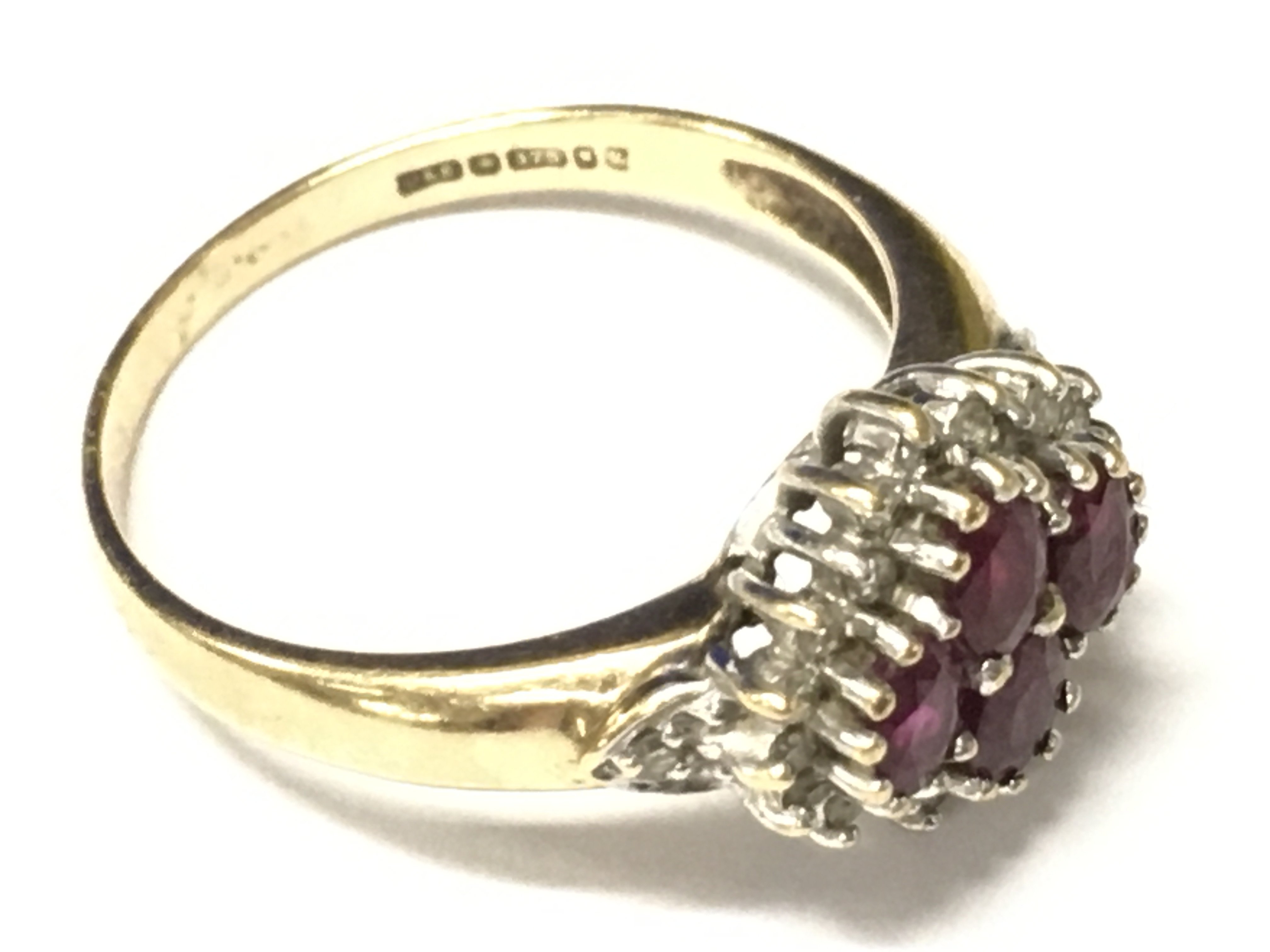 A 9ct gold ring set with rubys and small white stones. Approx size R, Approx weight 3.33 grams.