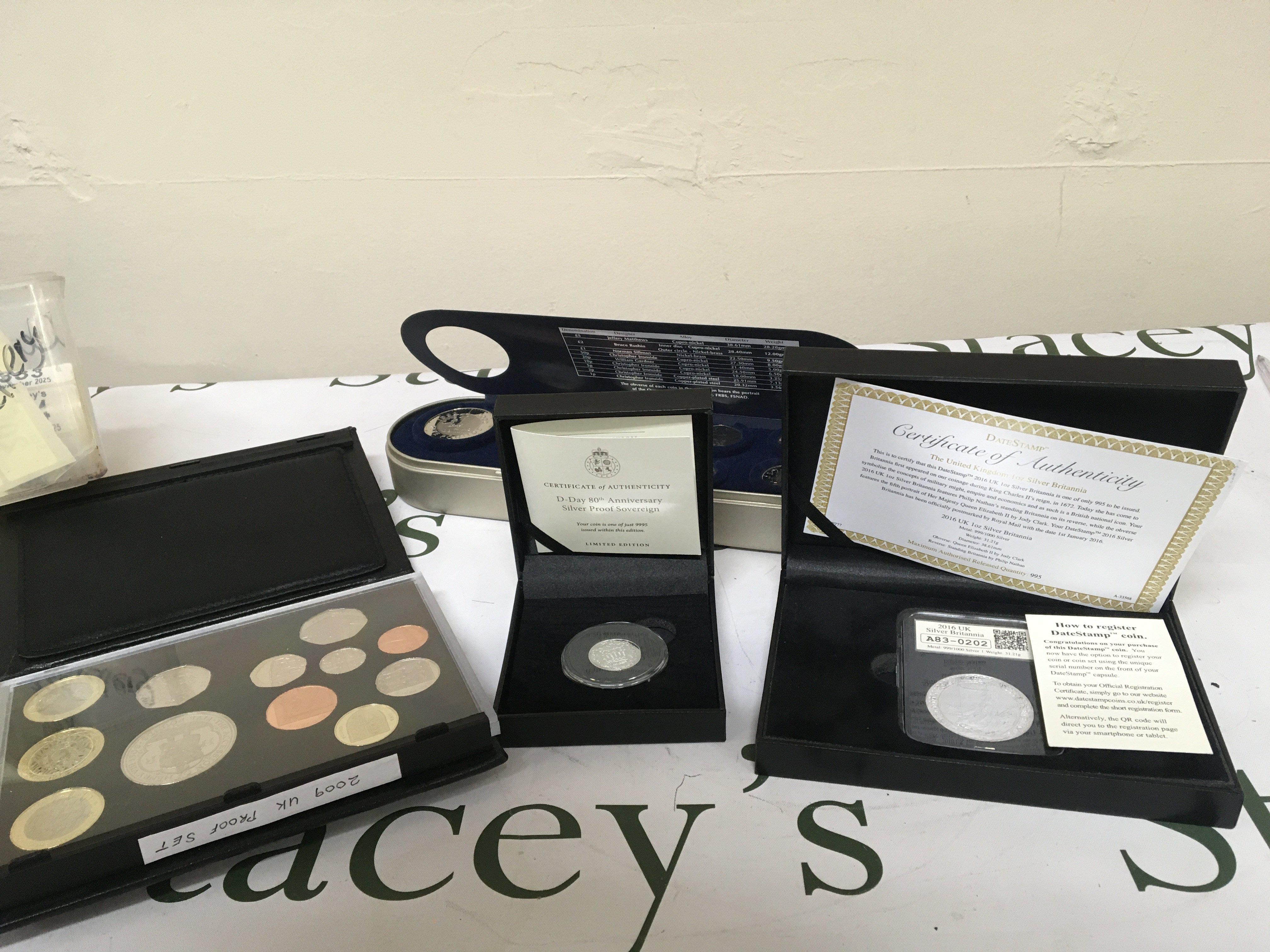 A collection of coins comprising a cased Silver Proof Sovereign a one ounce Silver Britannia coin 2009 U.K. Coin proof set and a Royal Mint Time Capsule Coin set.