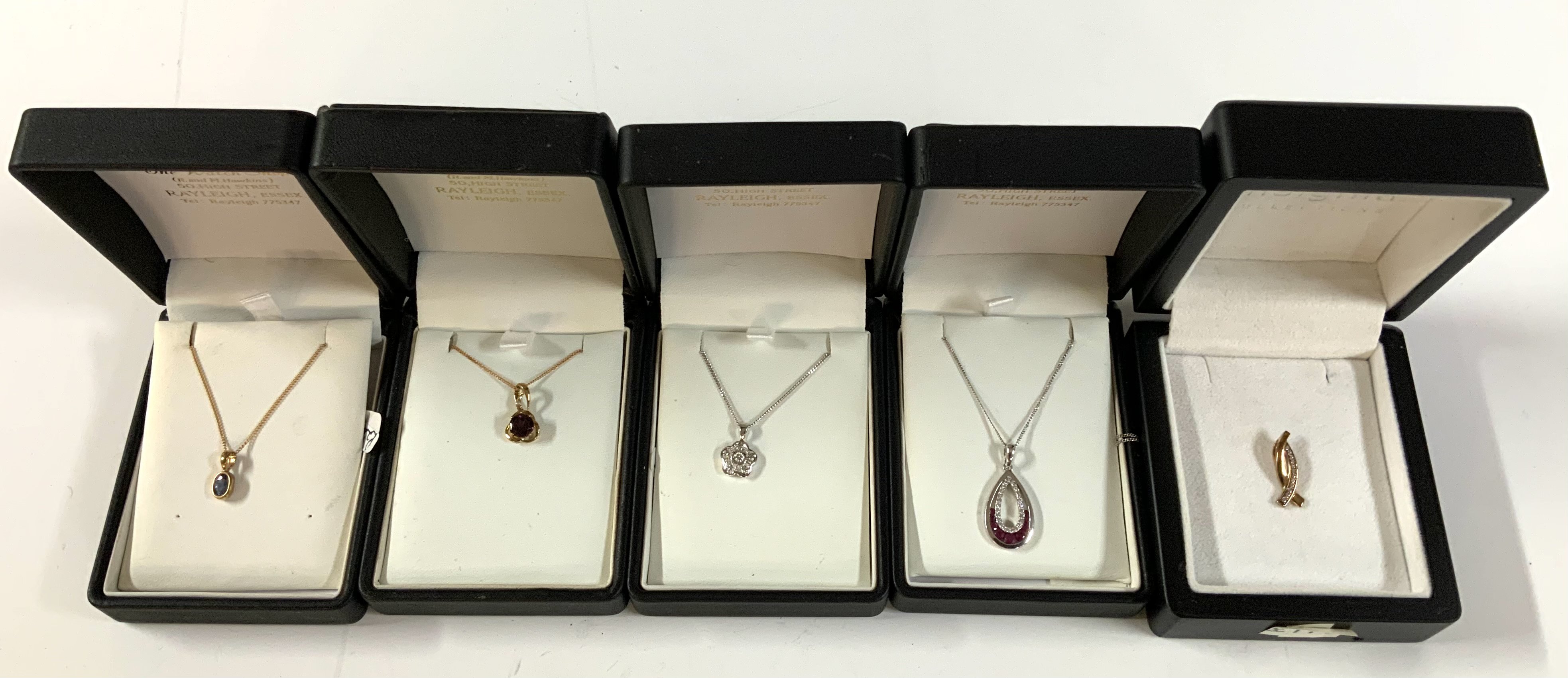 5 9ct gold stone set and pendants and 4 chains. (A)
