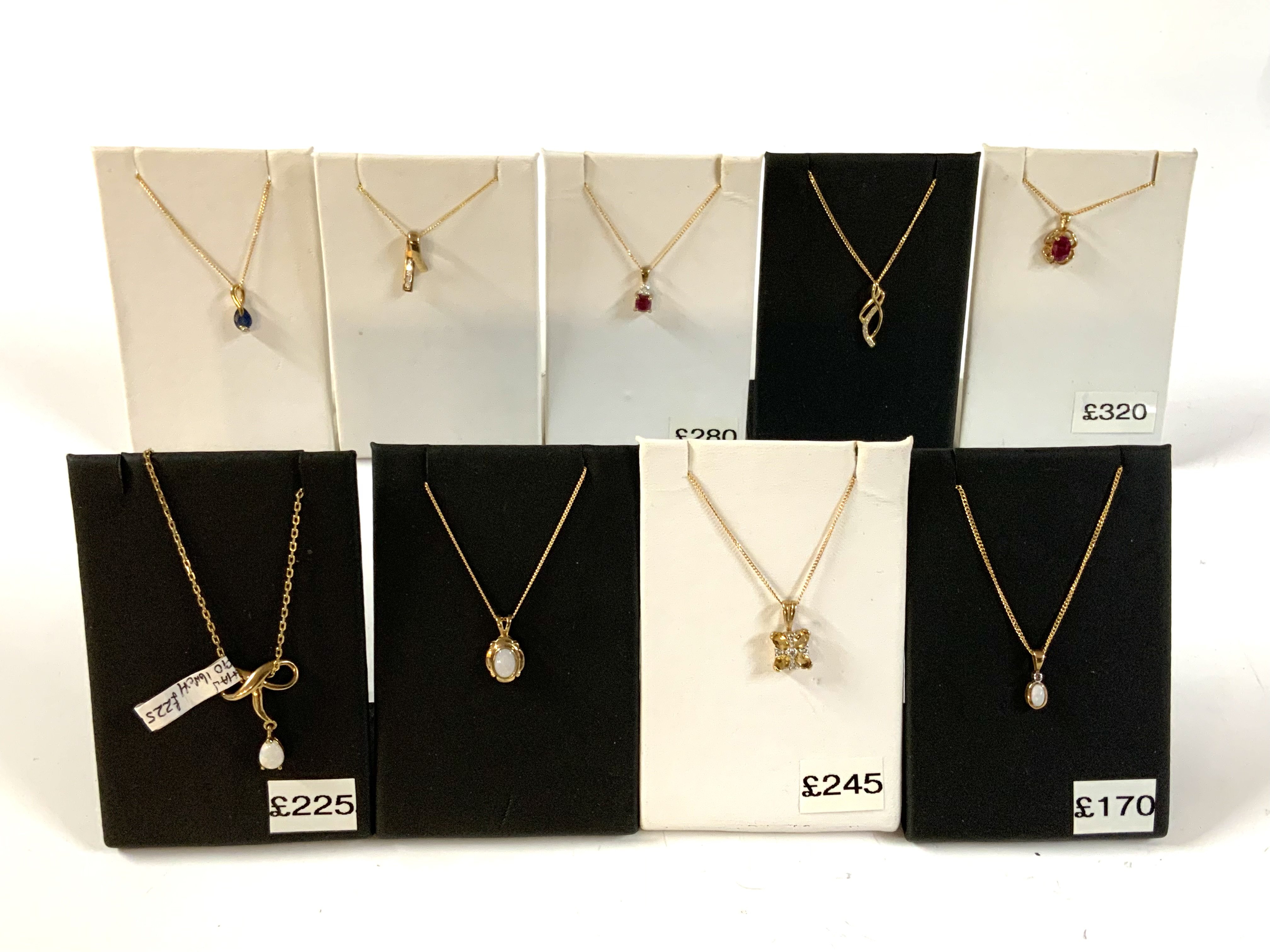 9 good quality 9ct gold and stone set pendants and chains.