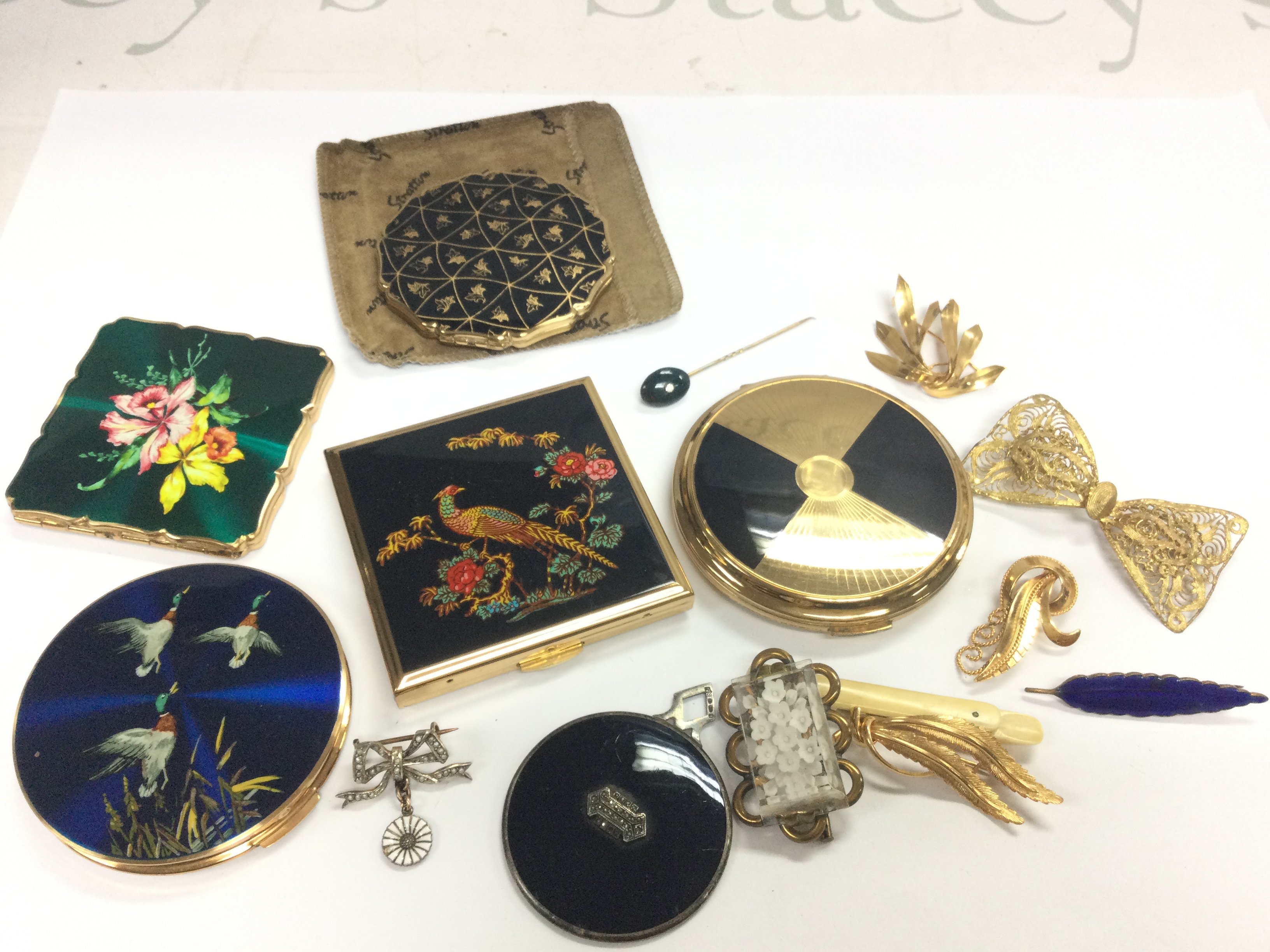 Seven brooches blood stone stick pin five compacts . Postage category B