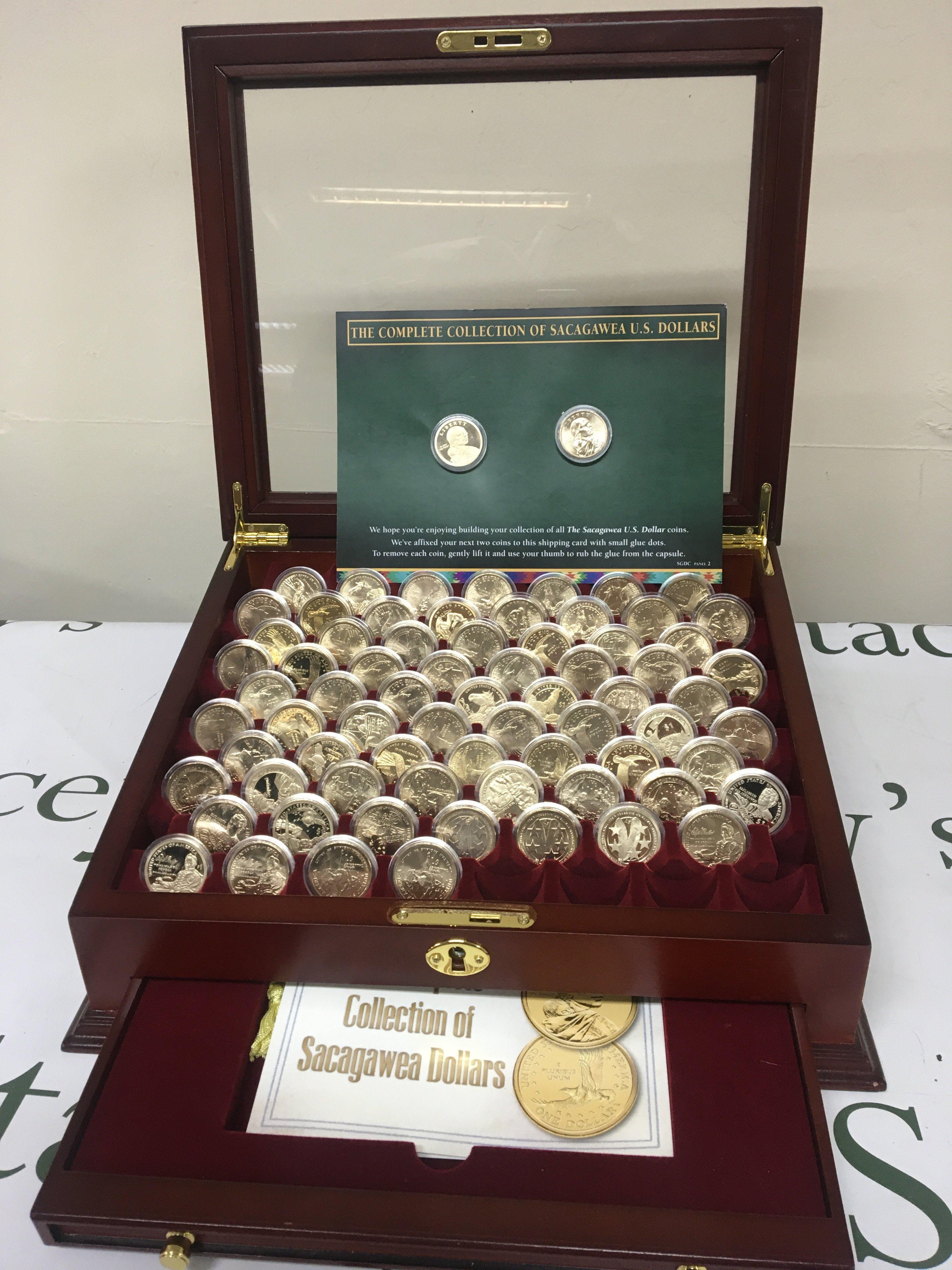 A case set of near complete of American Sacagawea Dollars in a well presented lined and fitted case each coin in mint condition and in clear capsule cases.