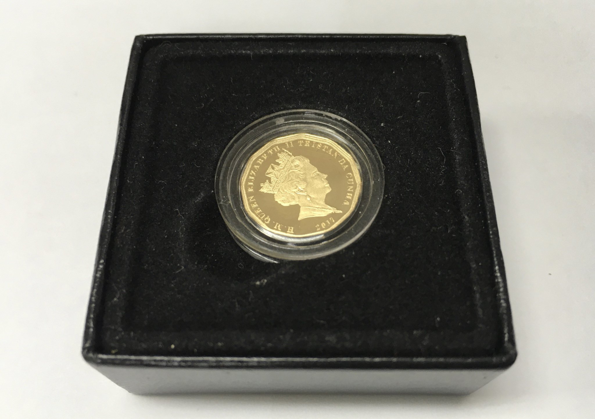 A quarter gold sovereign and other silver coinage.