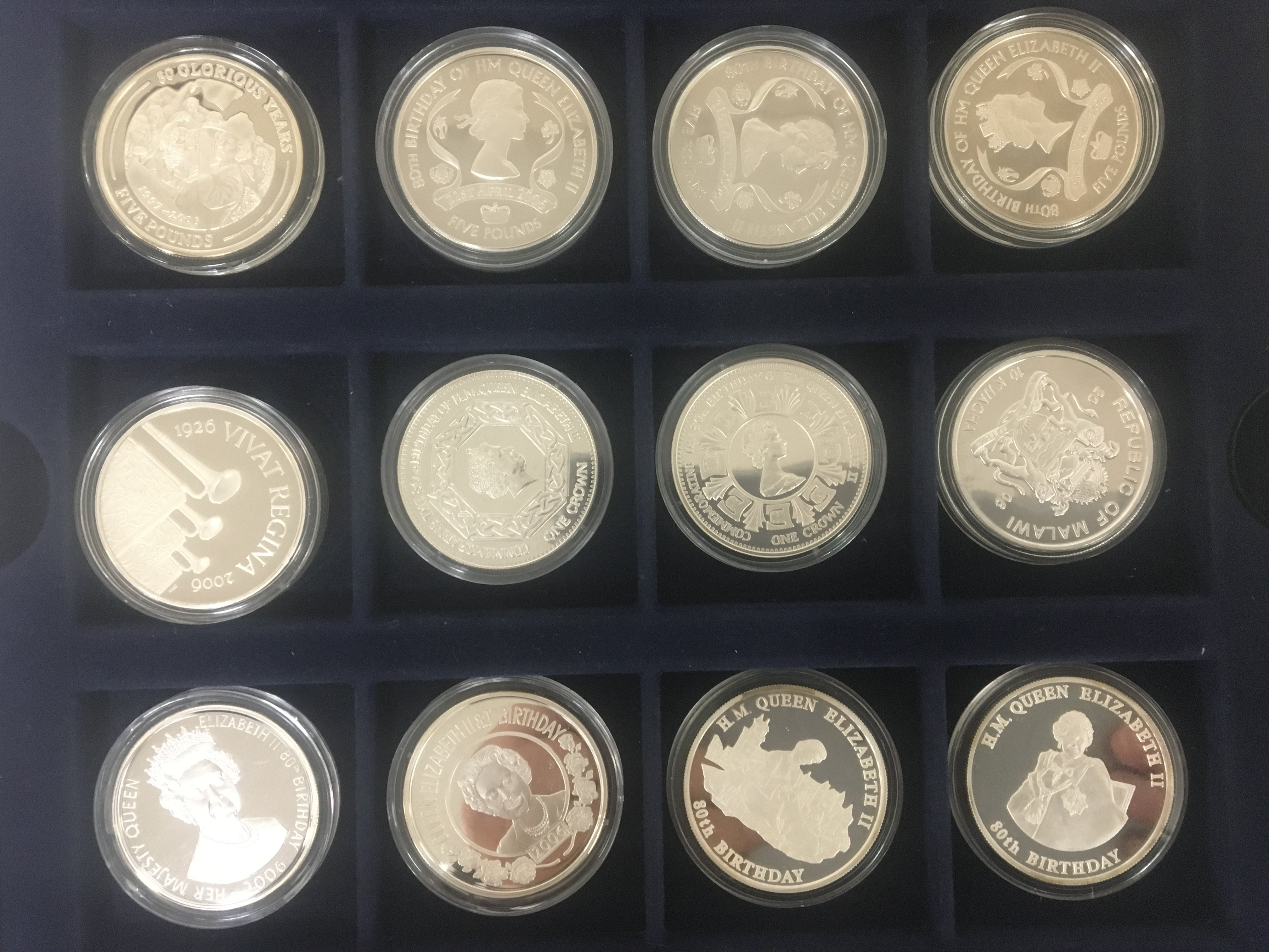A collection of silver proof and other coins thirty two mixed commemorative coins all in plastic capsules.