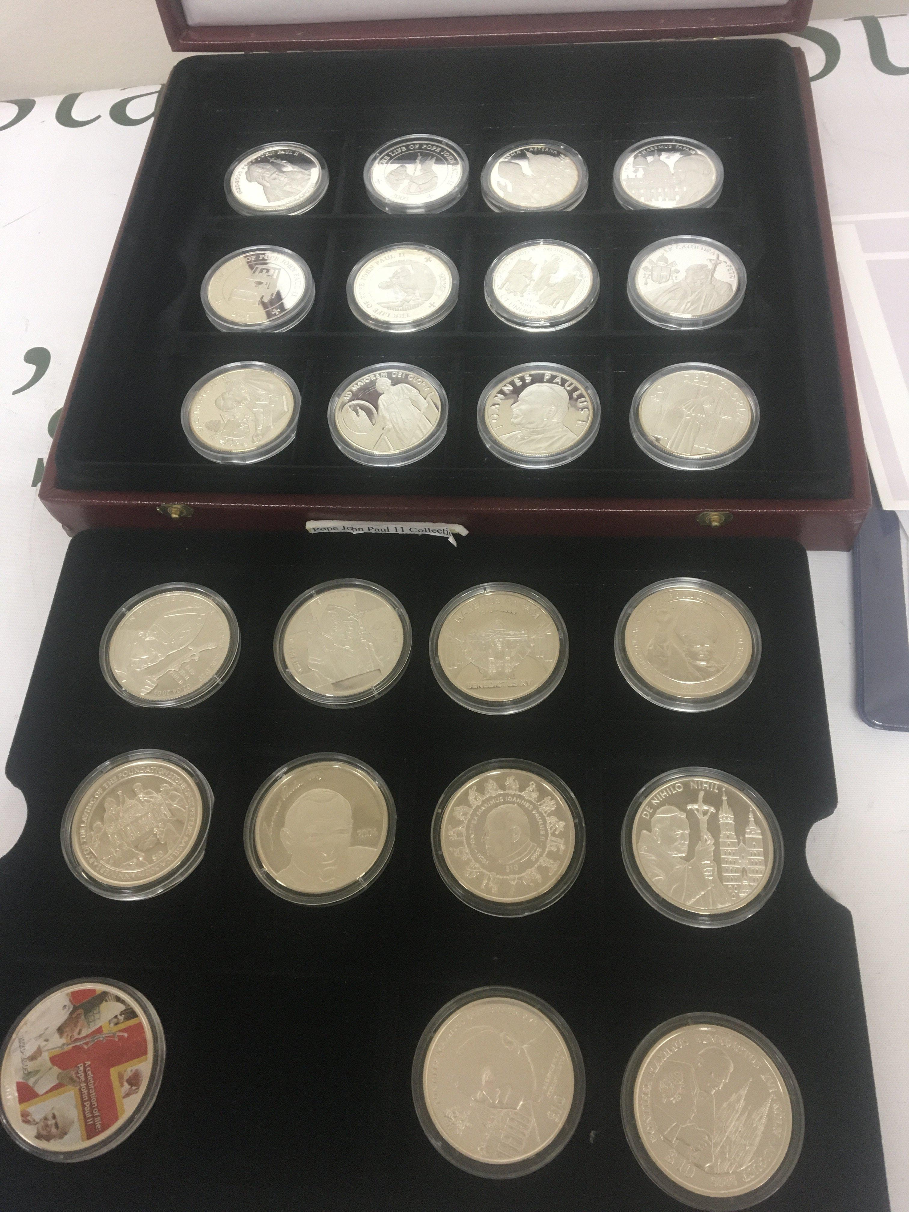A collection of silver commemorative coins The Pope John Paul II collection with certificates the case containing twenty four coins.
