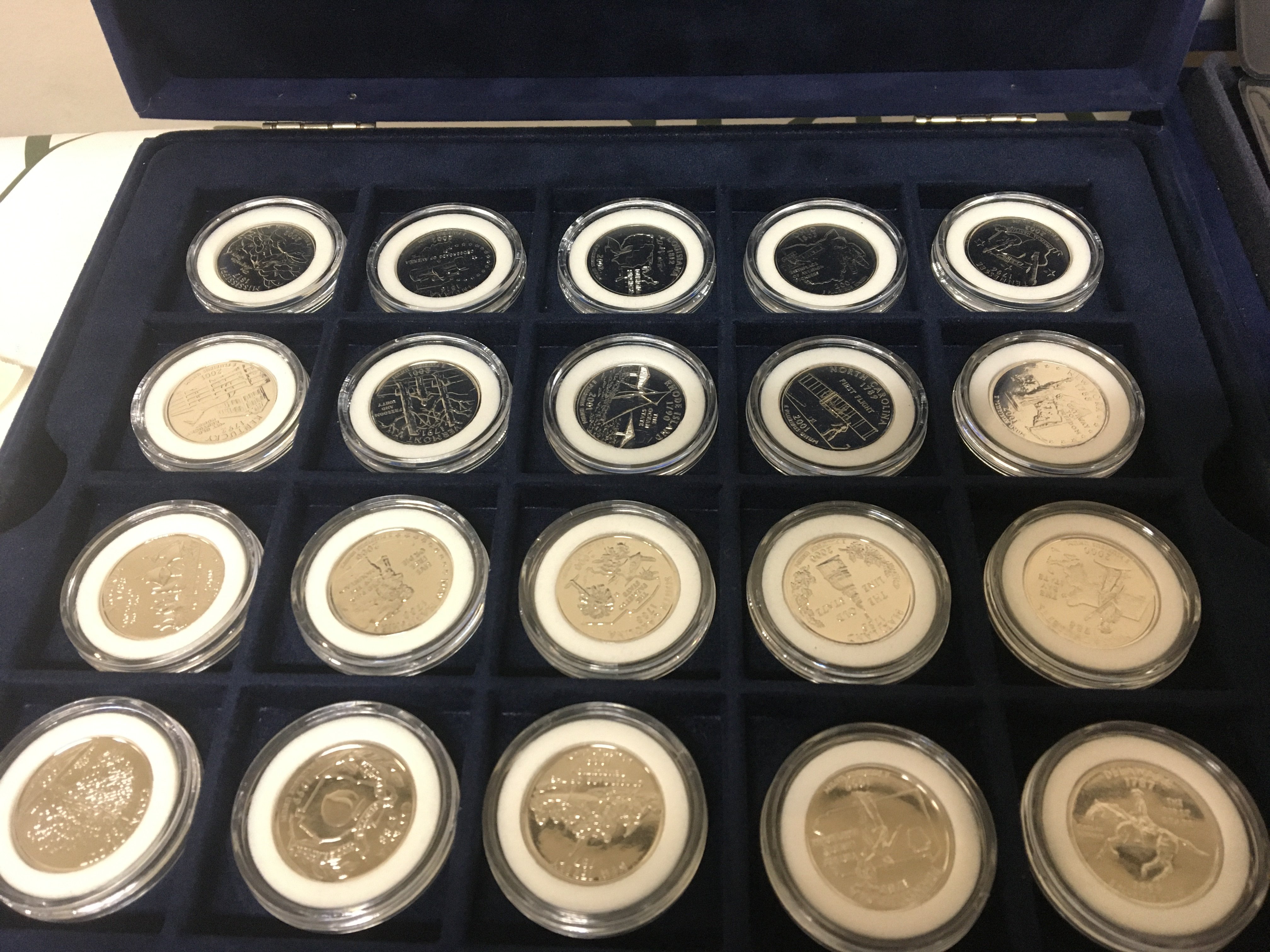 Three cased sets of American coins Platinum plated 50 state Quarter set Presidents Gold Plated Dollar set and one other gold plated 50 state Quarter sets. (3)